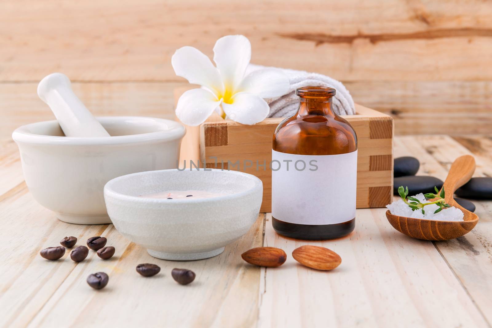 Natural Spa Ingredients sea salt ,coffee beans ,honey , almonds ,spa stones and white mortar on wooden background for scrub and skin care.