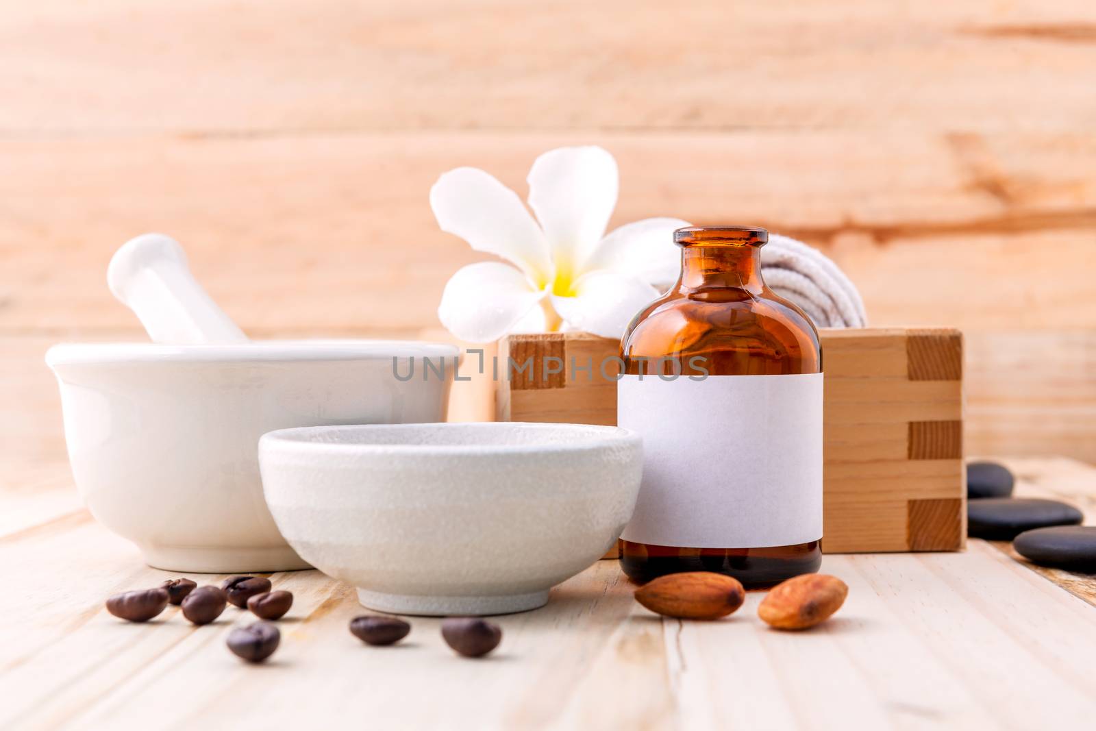 Natural Spa Ingredients sea salt ,coffee beans ,honey , almonds ,spa stones and white mortar on wooden background for scrub and skin care.