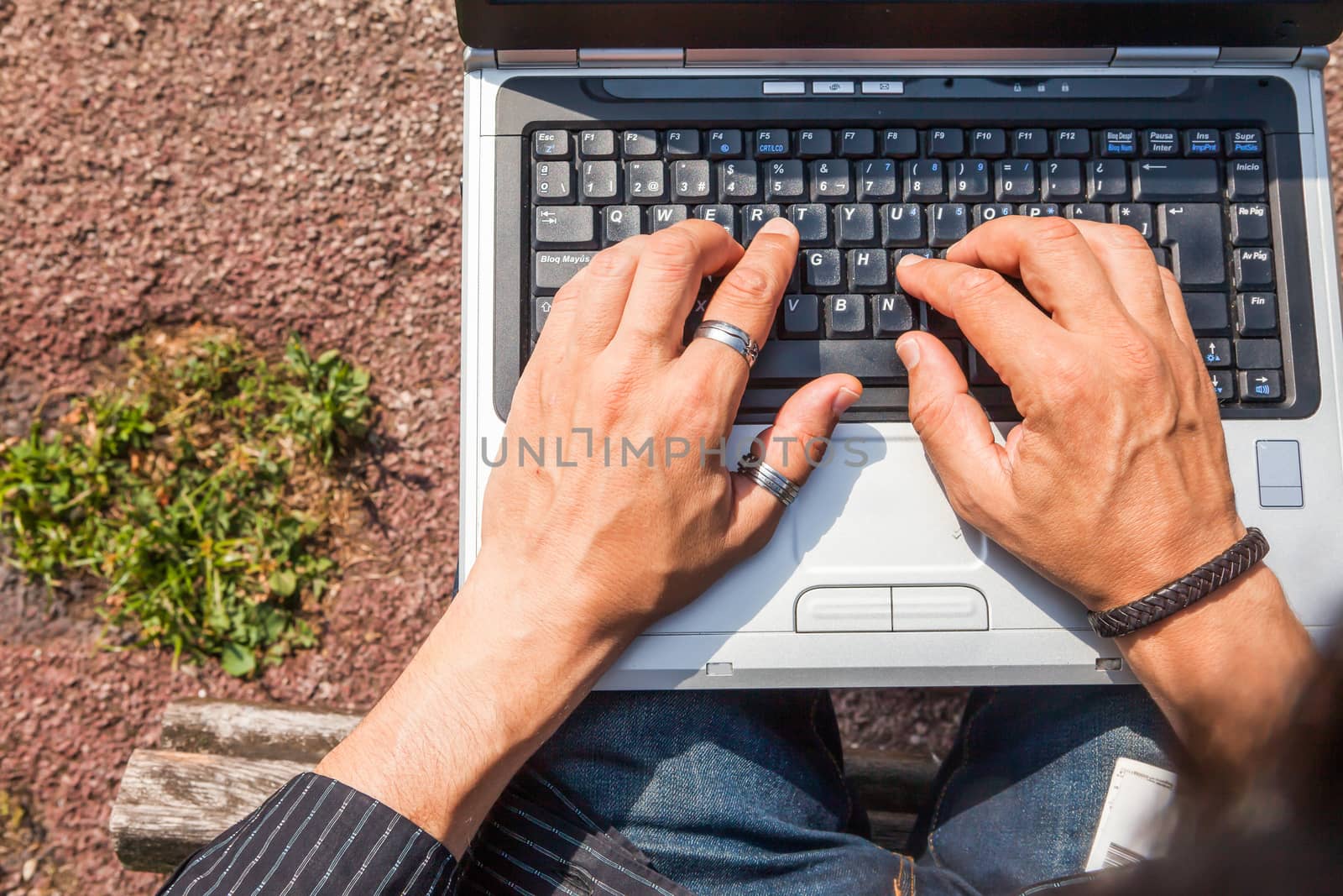 Human hands typing a laptop by andongob