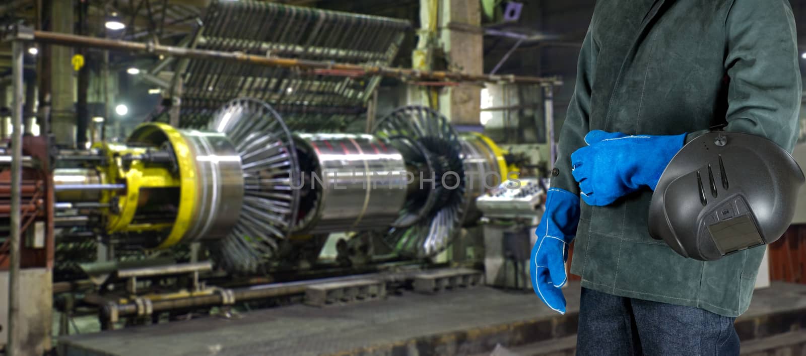 Worker welder with instruments at industrial factory