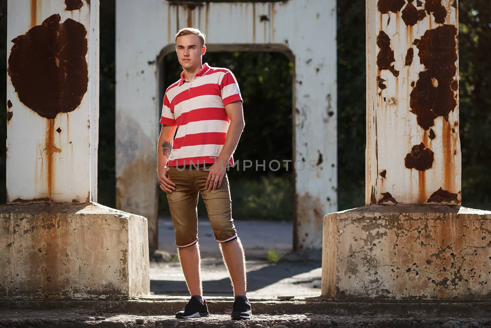 Handsome young man outdoor fashion shoot. Concept: beauty