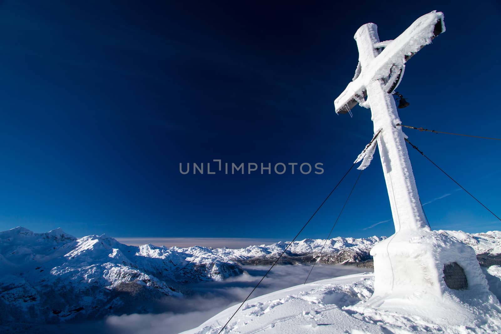 Cross on the top of mountain Vogel in slovenian Alps.