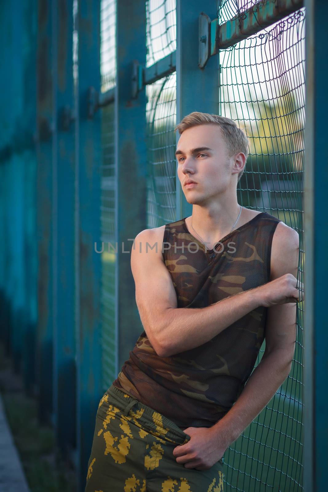 Muscular man in military pants outdoor fashion shoot