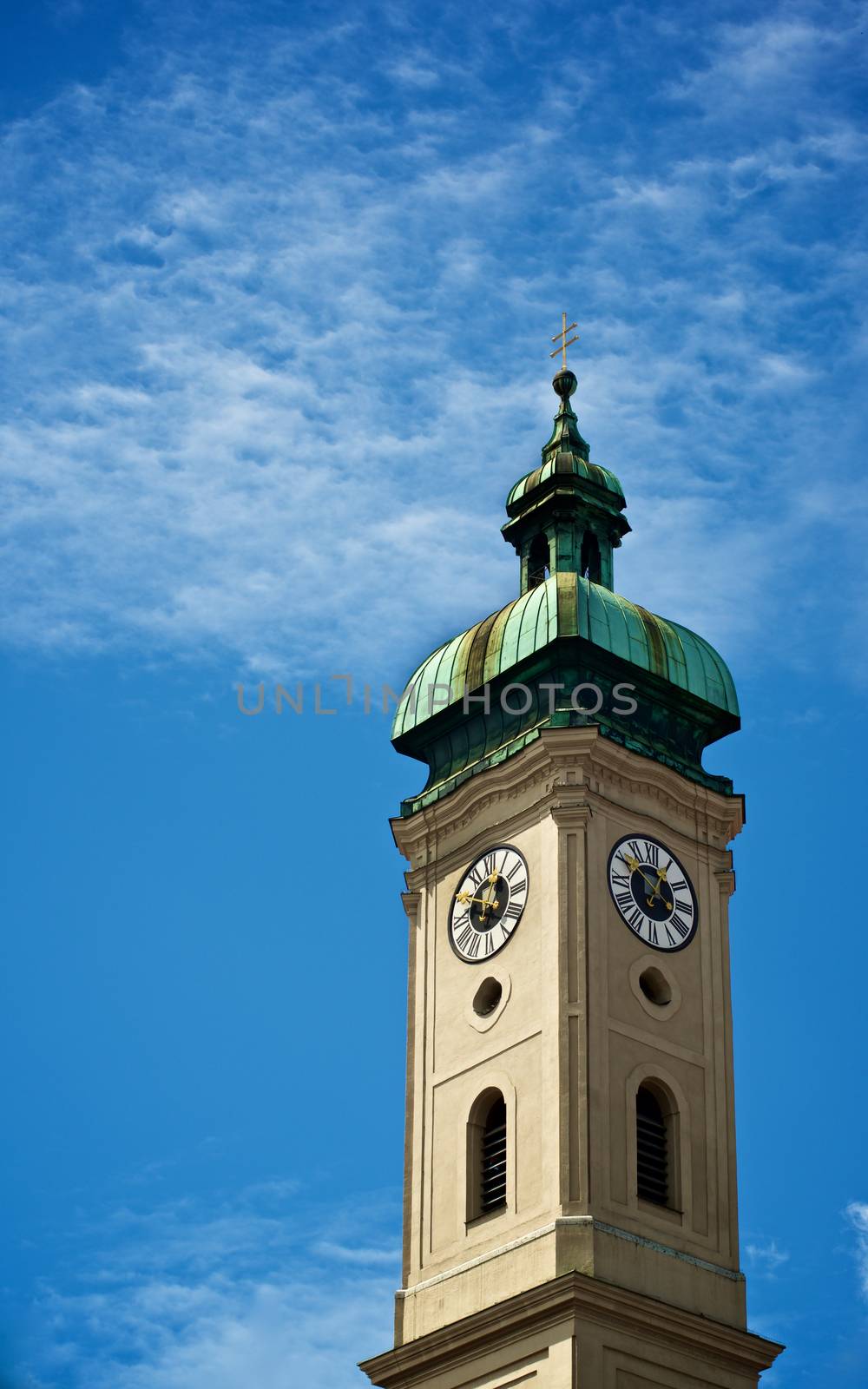 Clock Tower Heilig Geist Kirche against Blue Cloudy Sky Outdoors. Munich, Germany