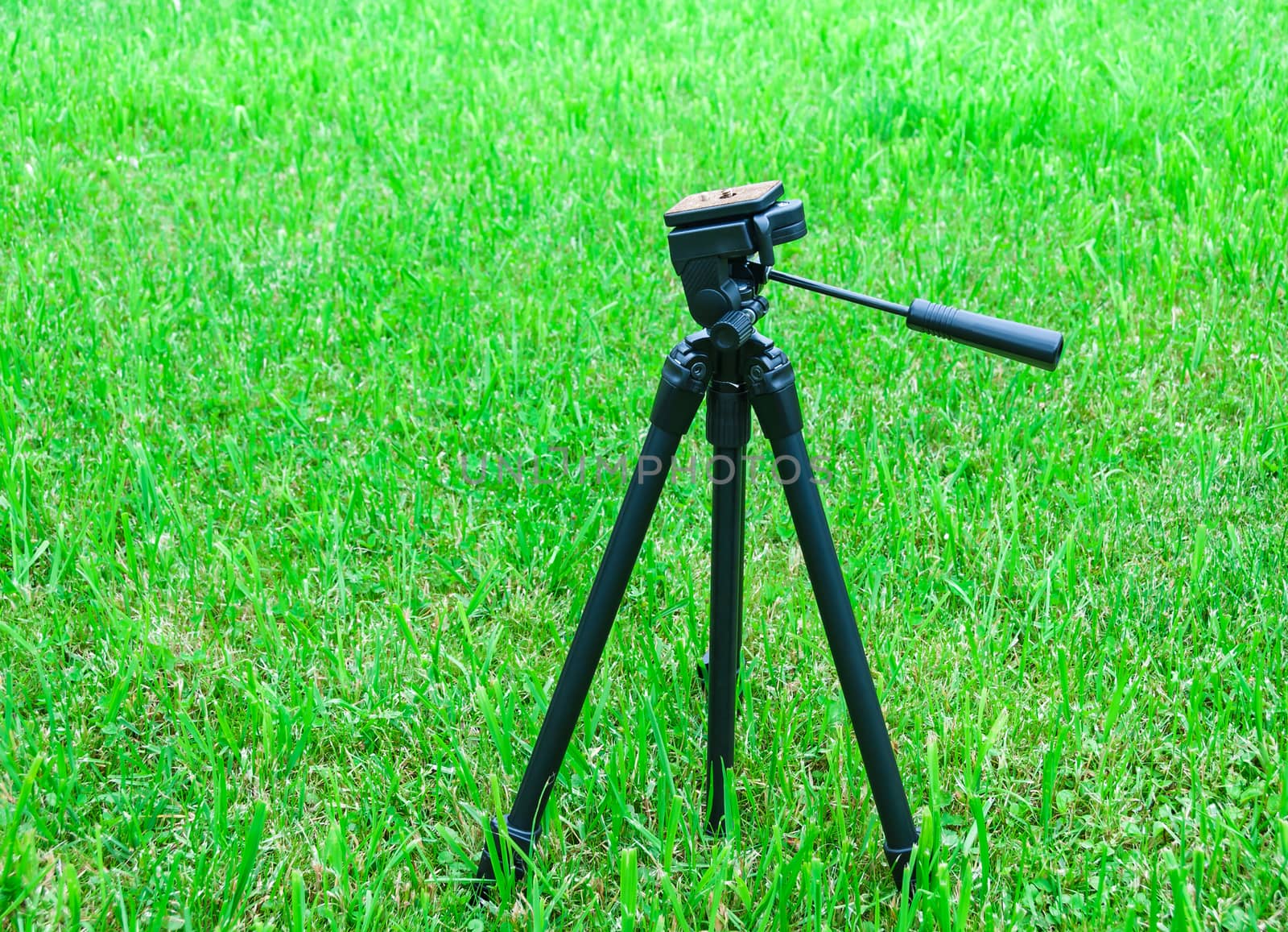A tripod for the camera on natural background