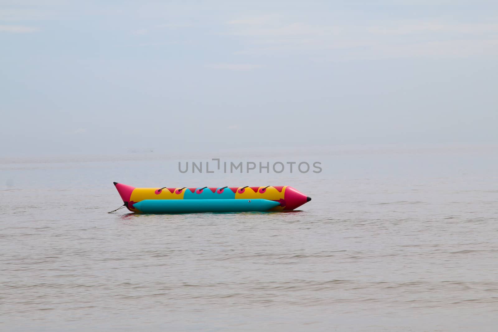 colorful banana boat floating on the water sea by N_u_T