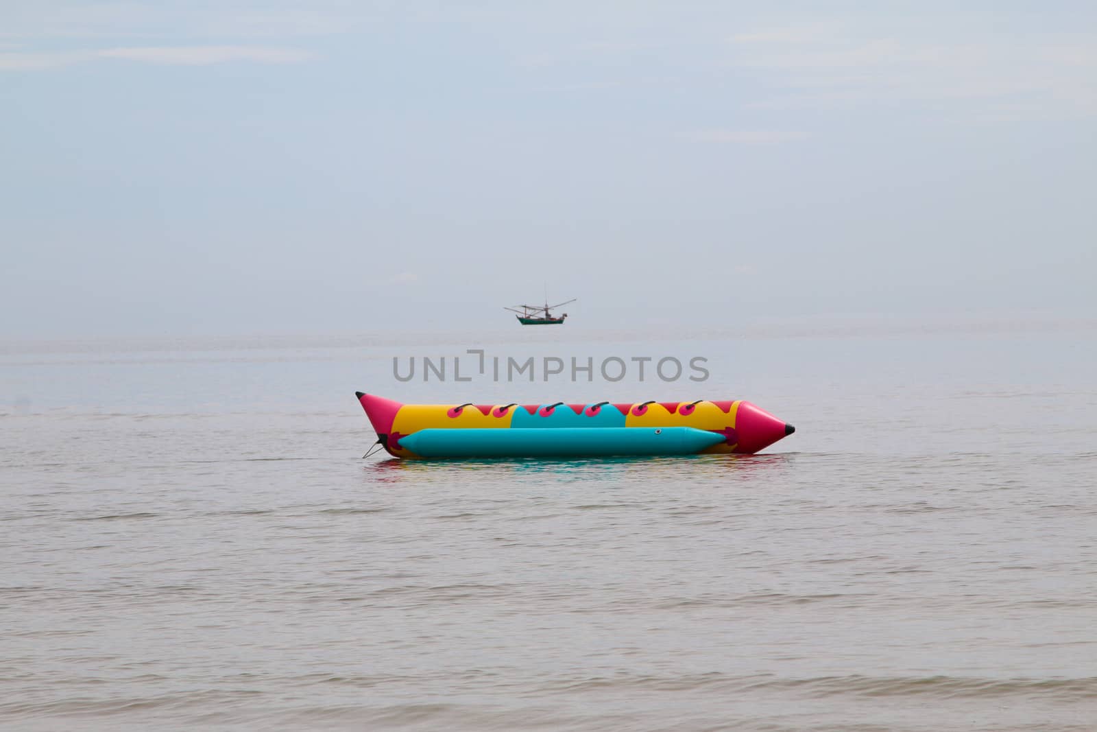 colorful banana boat floating on the water sea by N_u_T