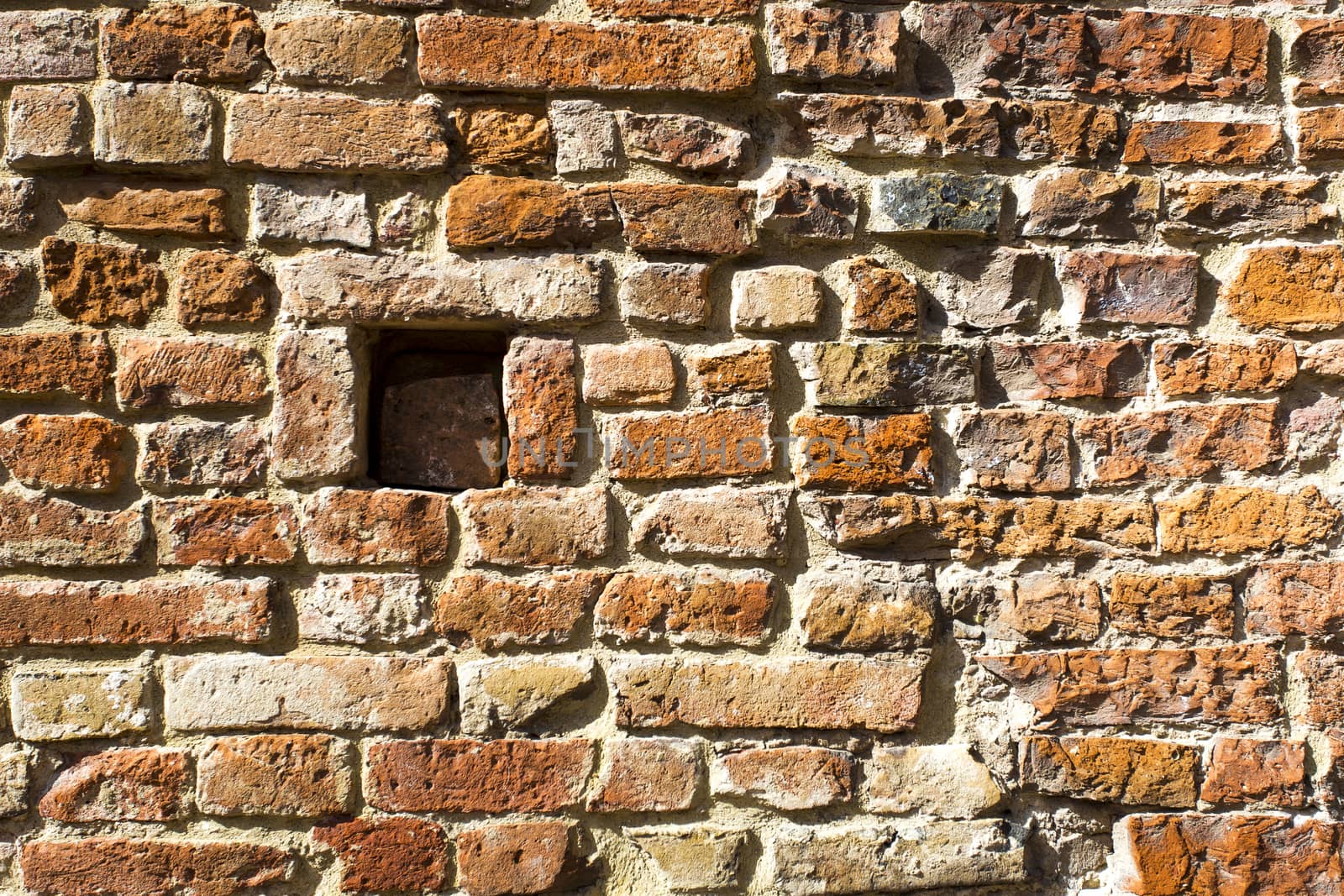 View of a detail of an ancient wall with grate