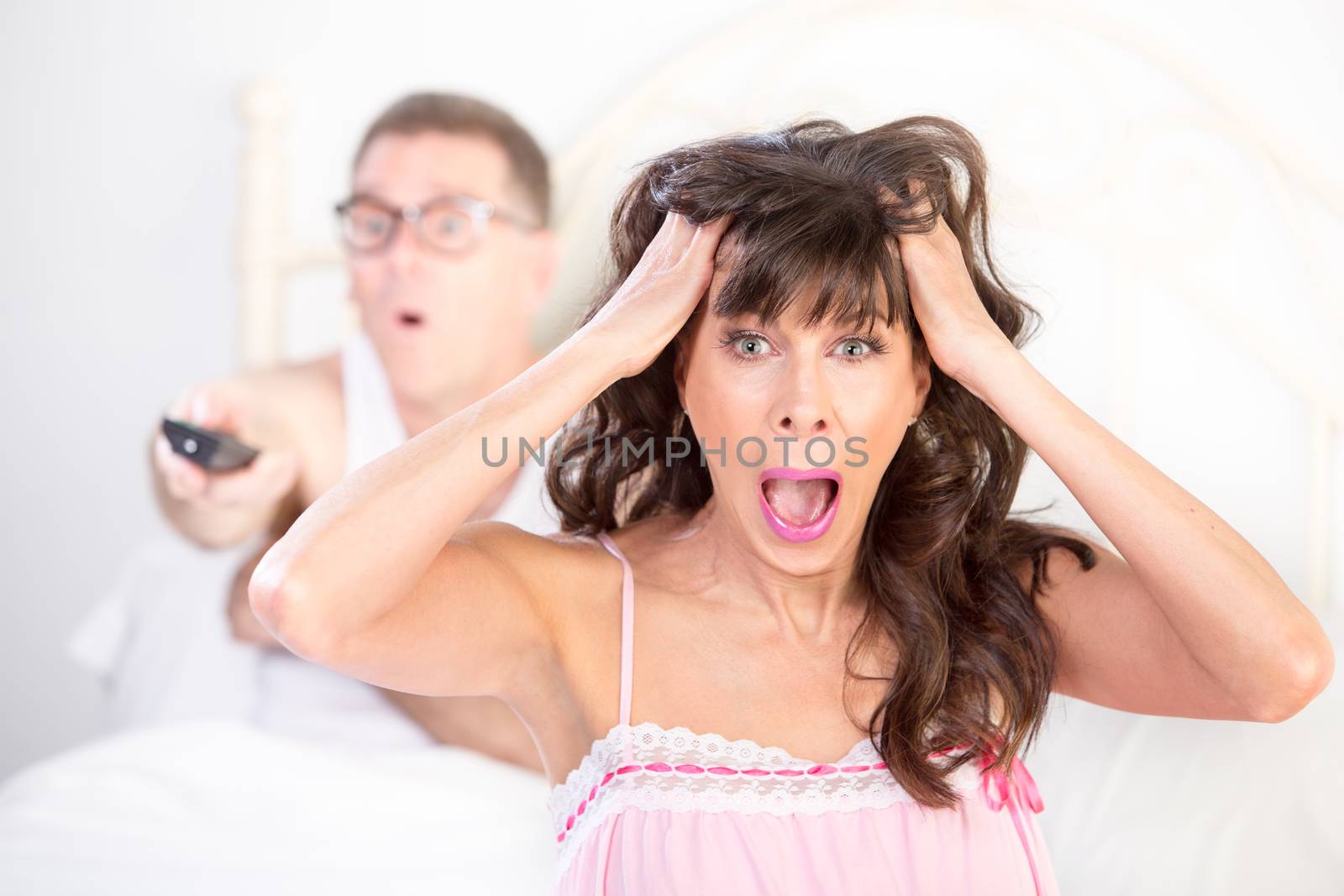 Frustrated Woman and  Man in Bed with Watching TV by Creatista