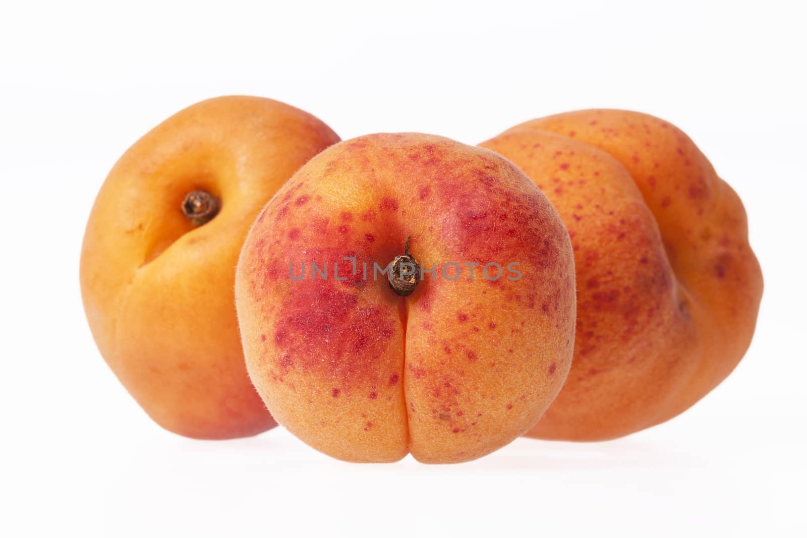 Whole ripe fruits of apricot isolated on white background, close up