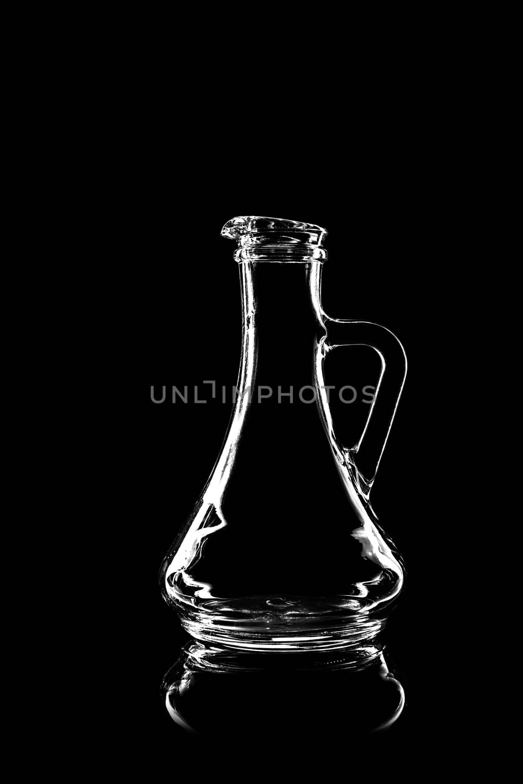 transparent glass for oil on black background with reflection