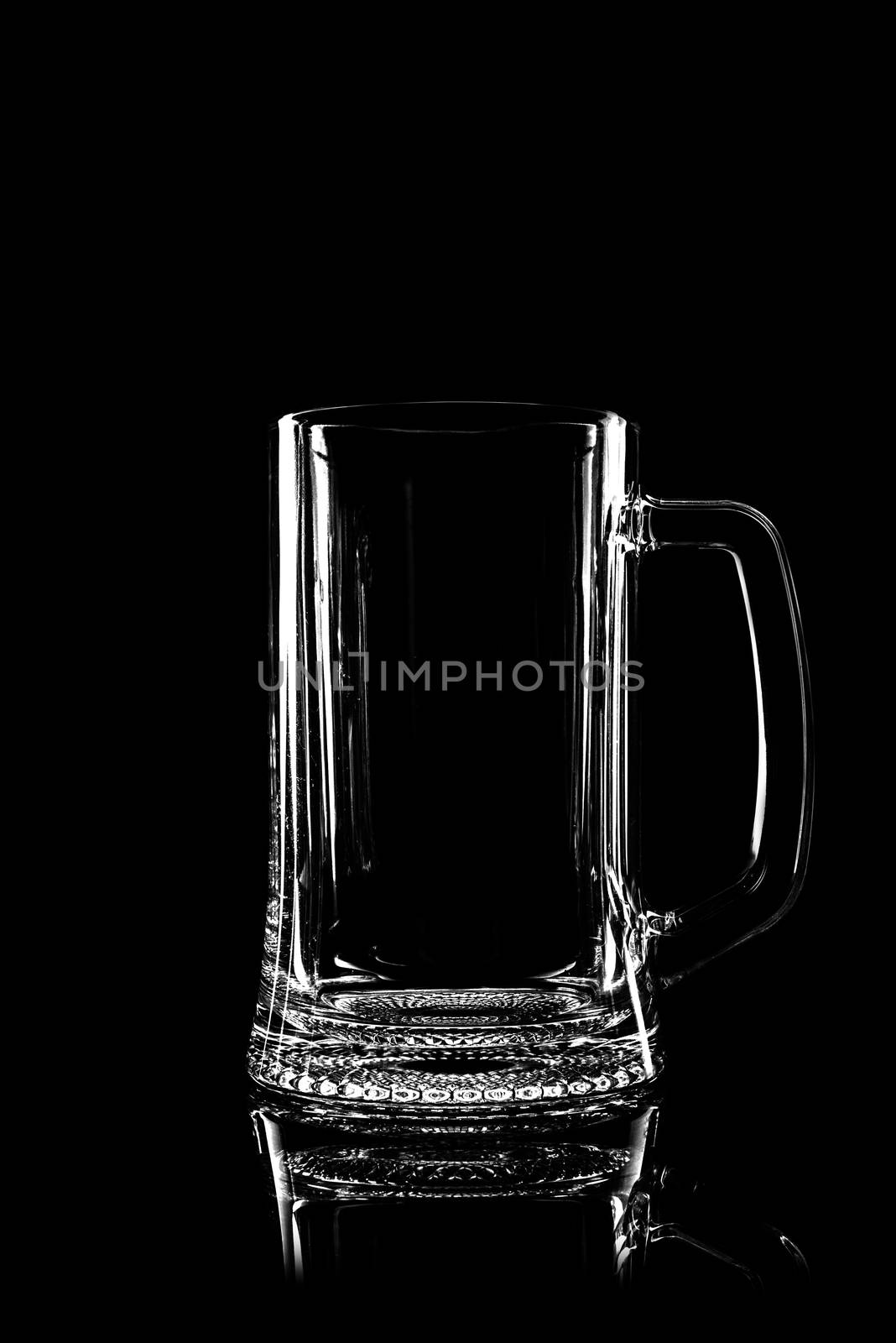 transparent glass for beer on black background with reflection