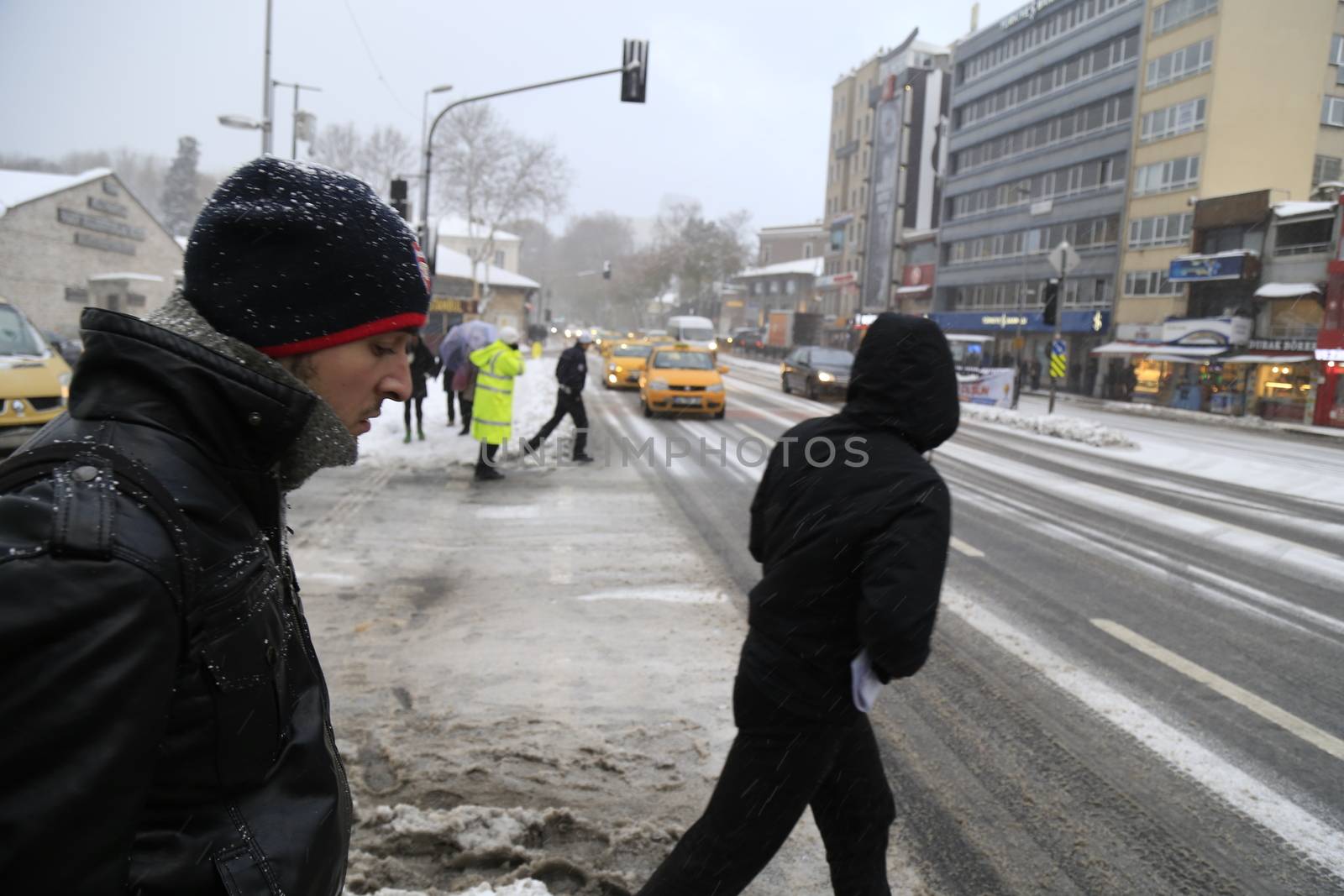 TURKEY, Istanbul : People walk towards a street during snowfall in Istanbul on New Year's Eve, December 31, 2015.Istanbul had a thick covering of snow early today, while almost 30 centimetres (12 inches) fell in some parts of the city, causing disruptions to transport services and the closure of several roads. 