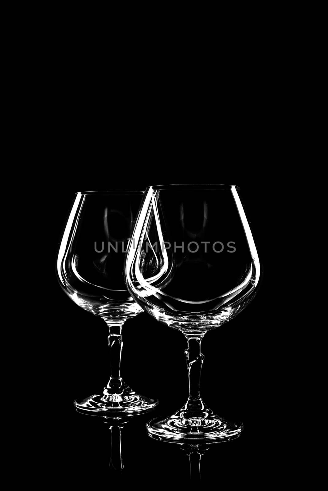 transparent glass for wine on black background with reflection