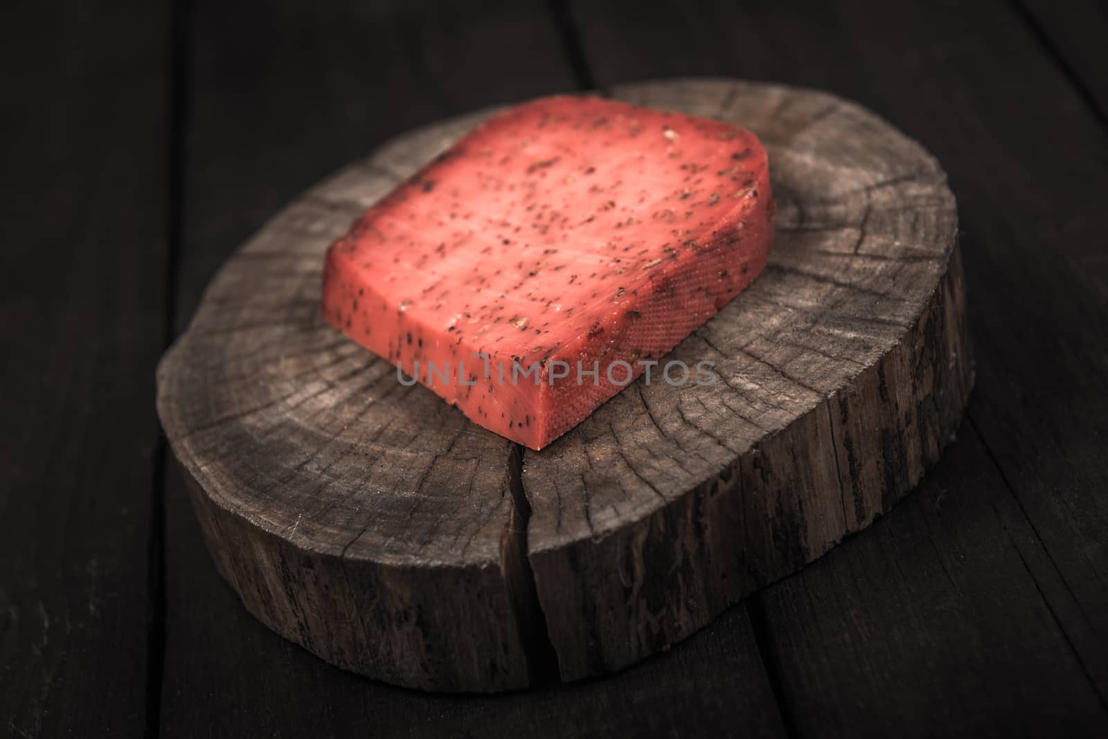 red hot tomato cheese pesto on wooden end of a tree