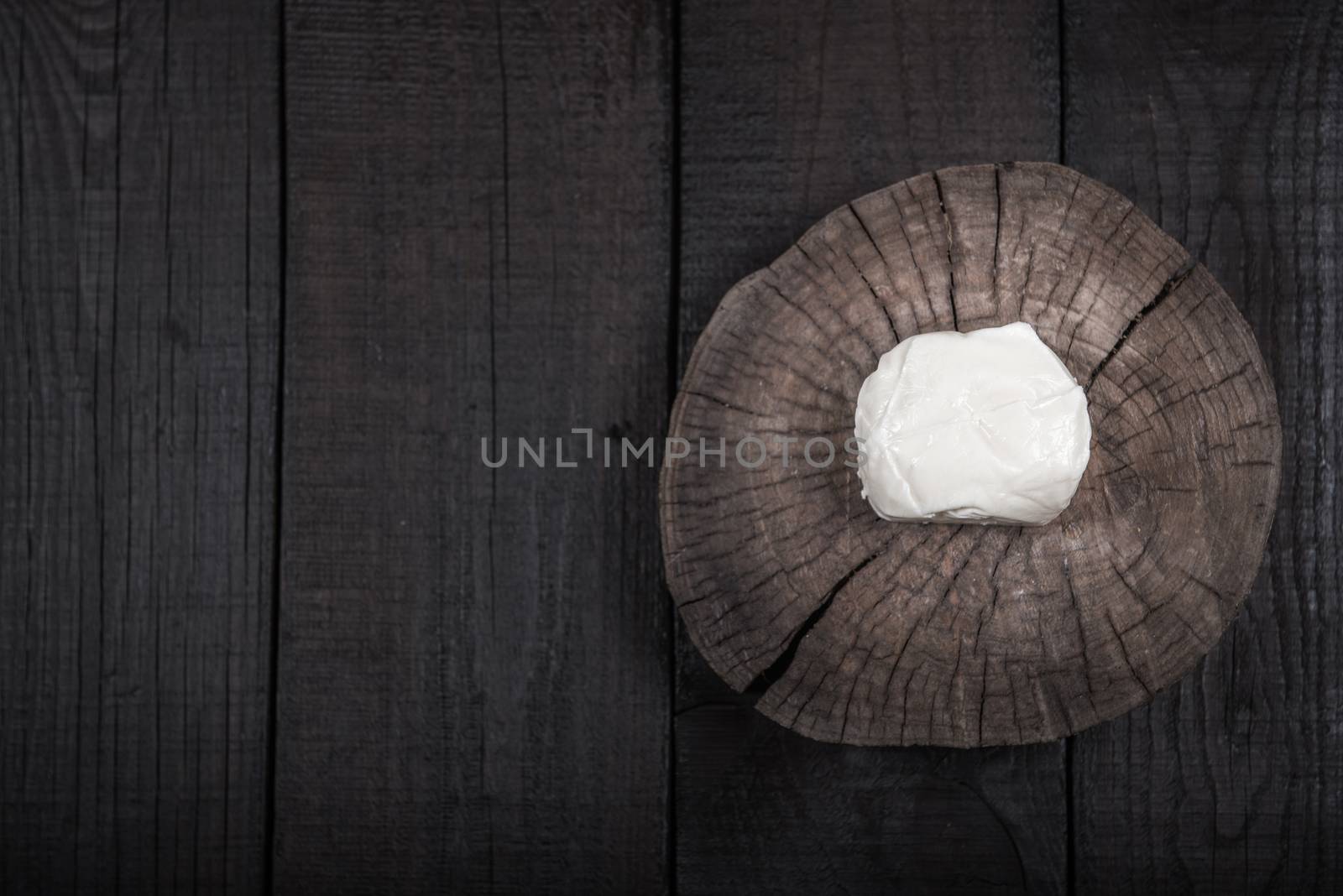 white mozzarella cheese on a wooden end of a tree