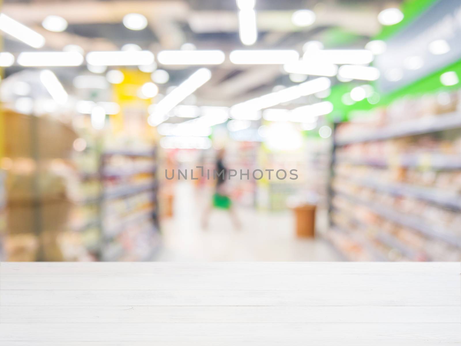 Wooden empty table in front of blurred supermarket by fascinadora