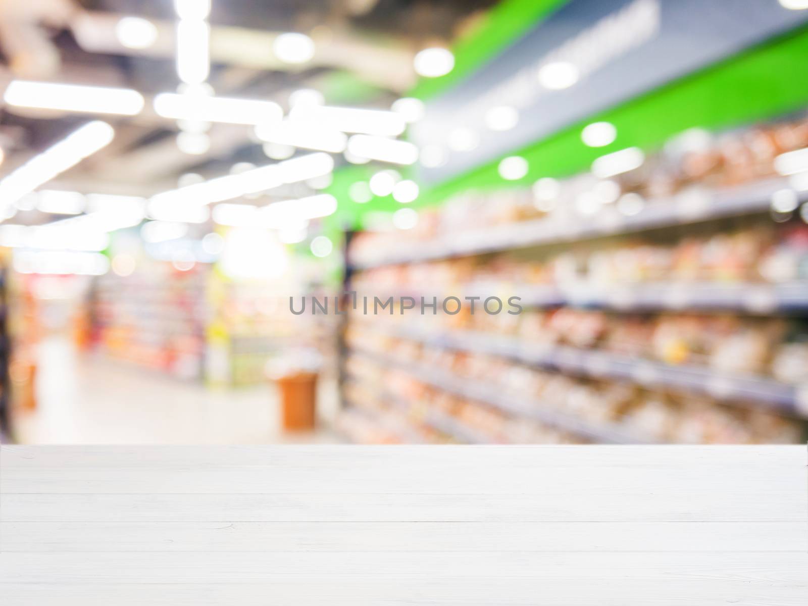 Wooden empty table in front of blurred supermarket by fascinadora