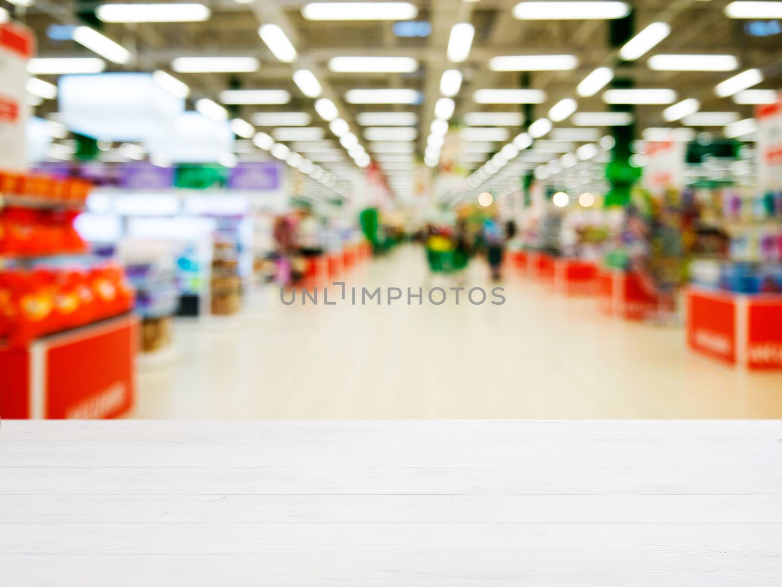 White wooden board empty table in front of blurred background. Perspective white wood over blur in supermarket - can be used for display or montage your products. Mockup for display of product.