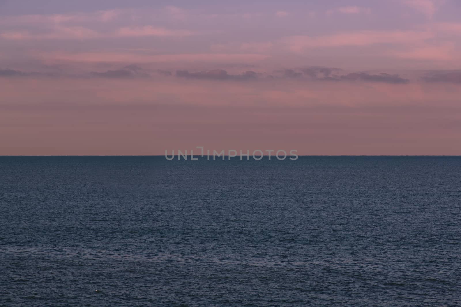 Seascape with a merchant ship in the background