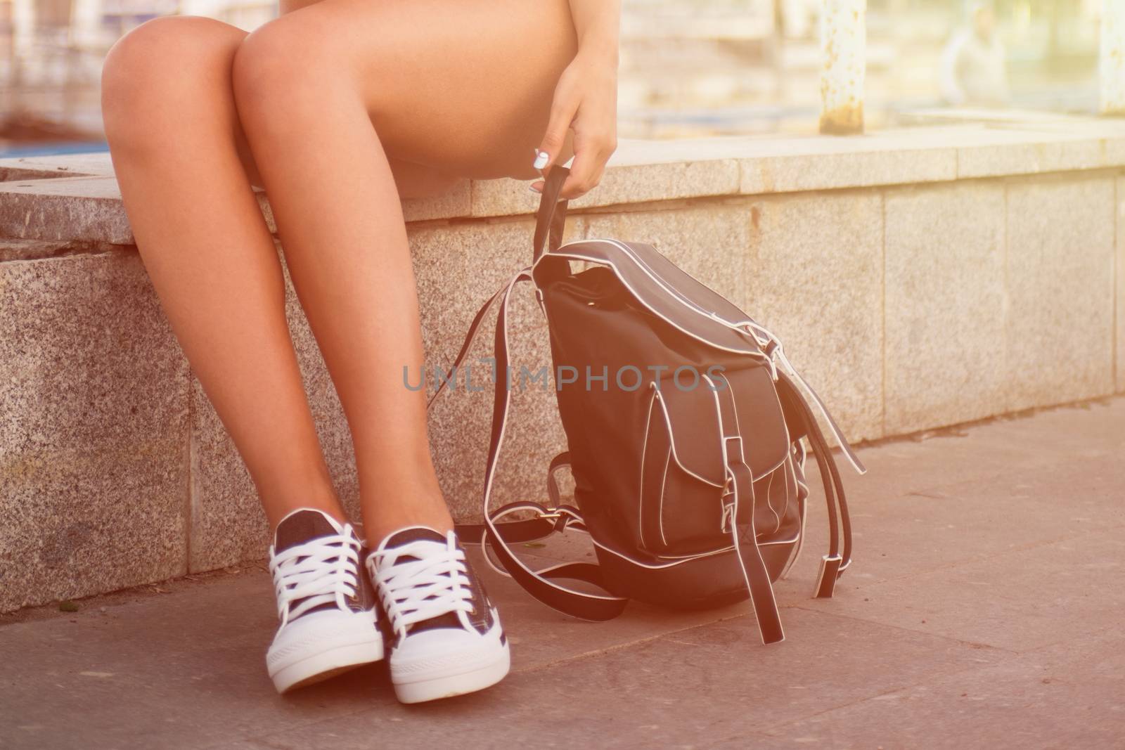 closeup of woman legs in white gumshoes, outdoor shot