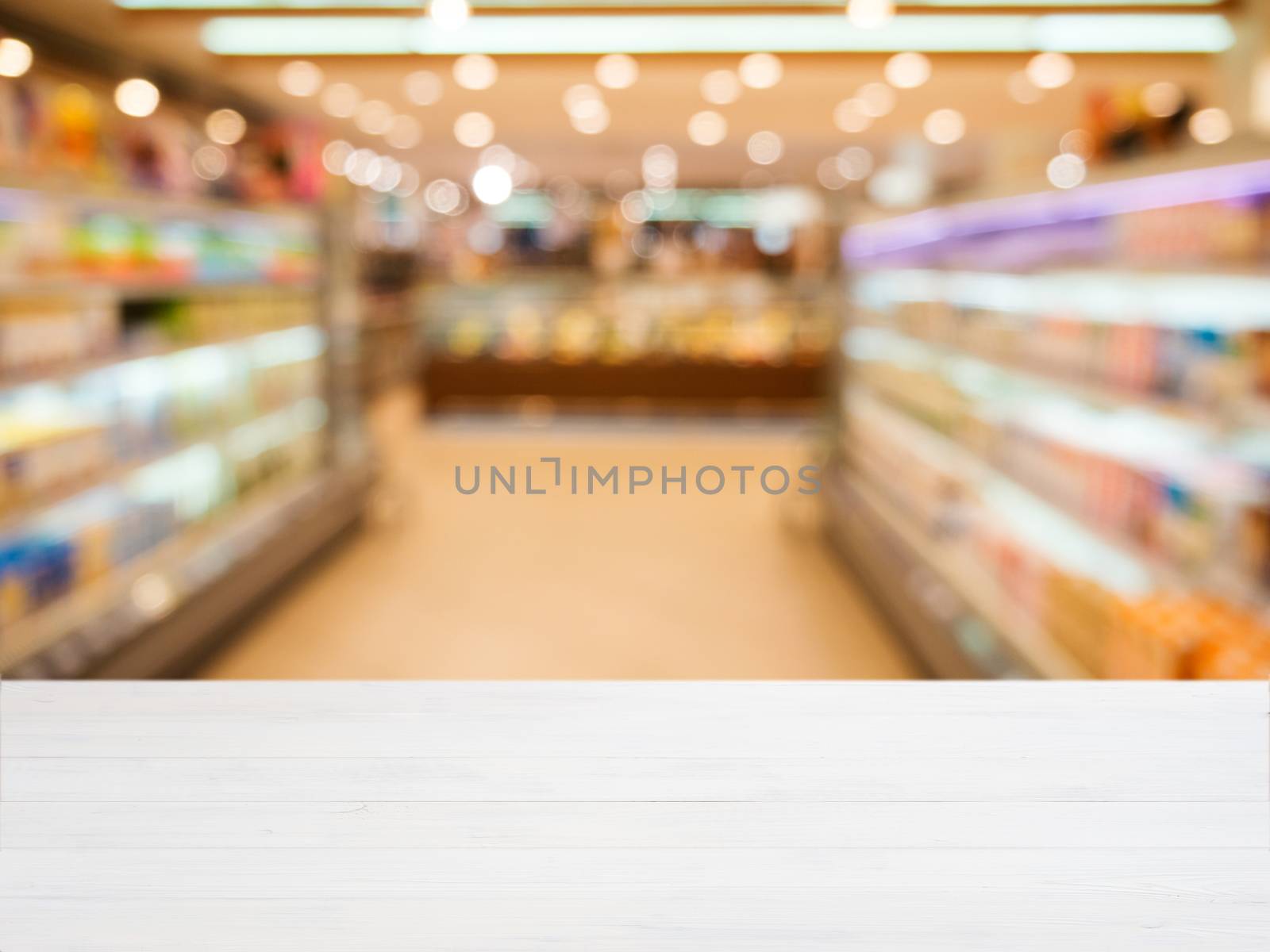 White wooden board empty table in front of blurred background. Perspective white wood over blur in supermarket - can be used for display or montage your products. Mockup for display of product.