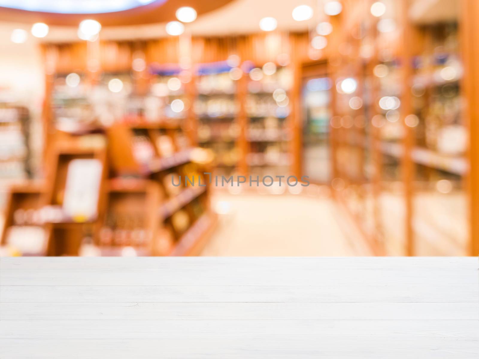 Wooden empty table in front of blurred supermarket by fascinadora