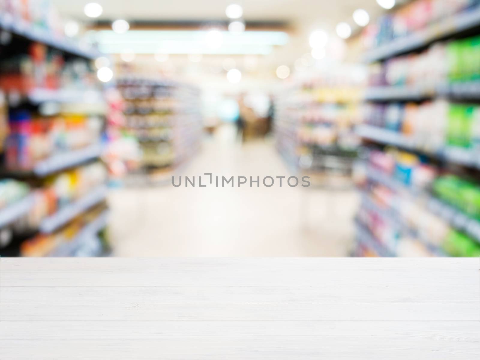 White wooden board empty table in front of blurred background. Perspective white wood over blur in supermarket - can be used for display or montage your products. Mockup for display of product.