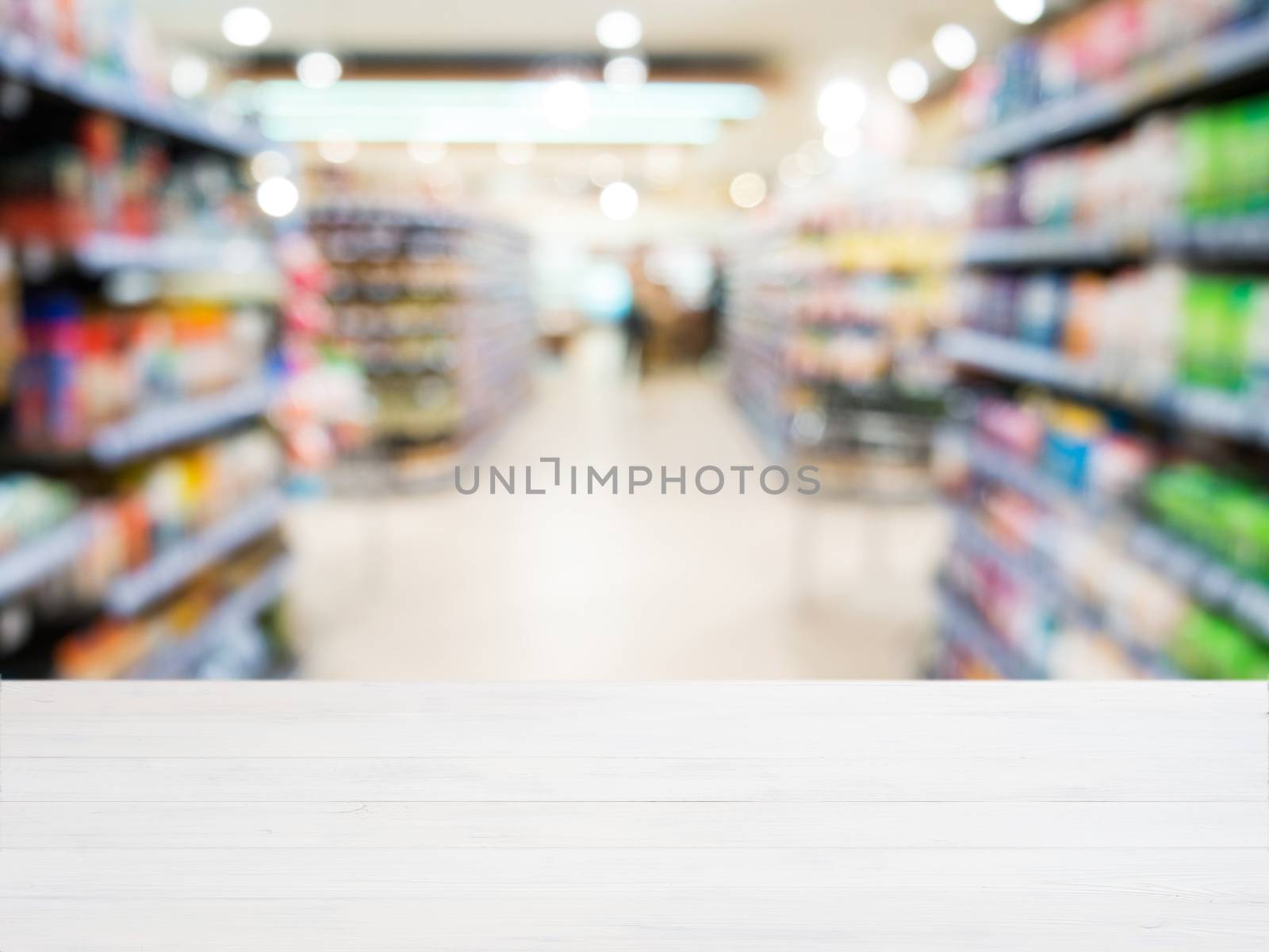 Wooden empty table in front of blurred supermarket by fascinadora