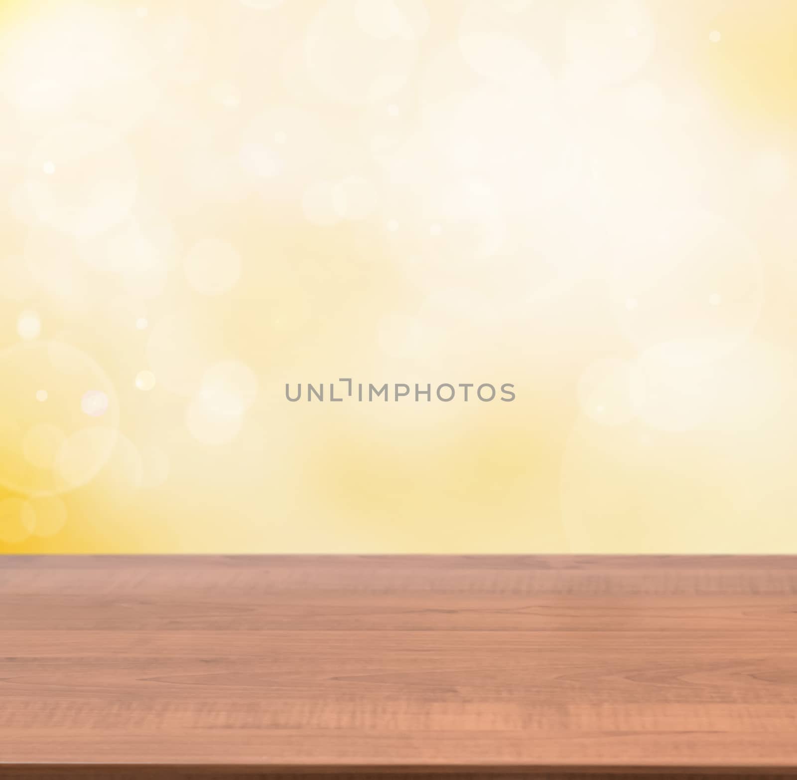 Dark wooden board empty table in abstract gold background with bokeh. Perspective brown wood board over blurred orange background - mockup for display of product
