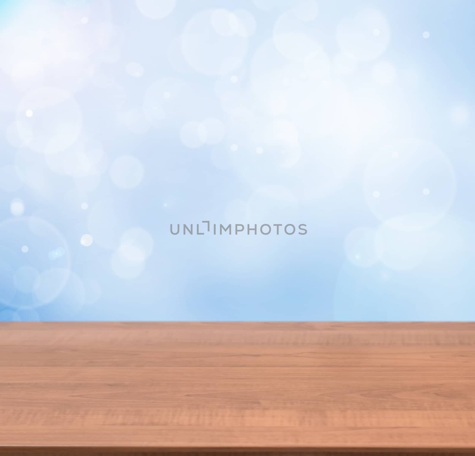 Dark wooden board empty table in abstract blue background with bokeh. Perspective brown wood board over blurred blue background - mockup for display of product