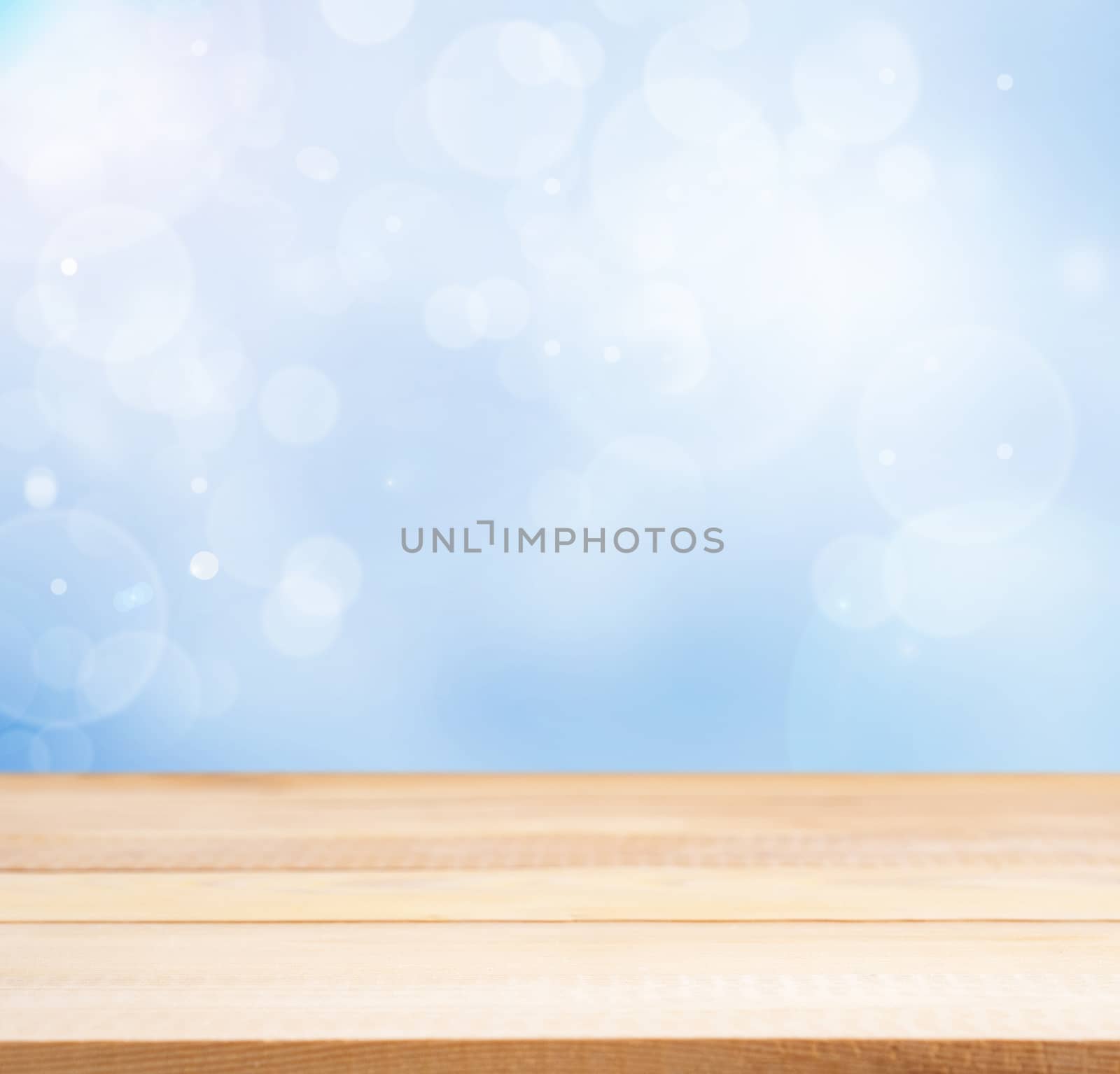 Wooden board empty table in abstract blue background with bokeh. Perspective light wood board over blurred blue background - mockup for display of product