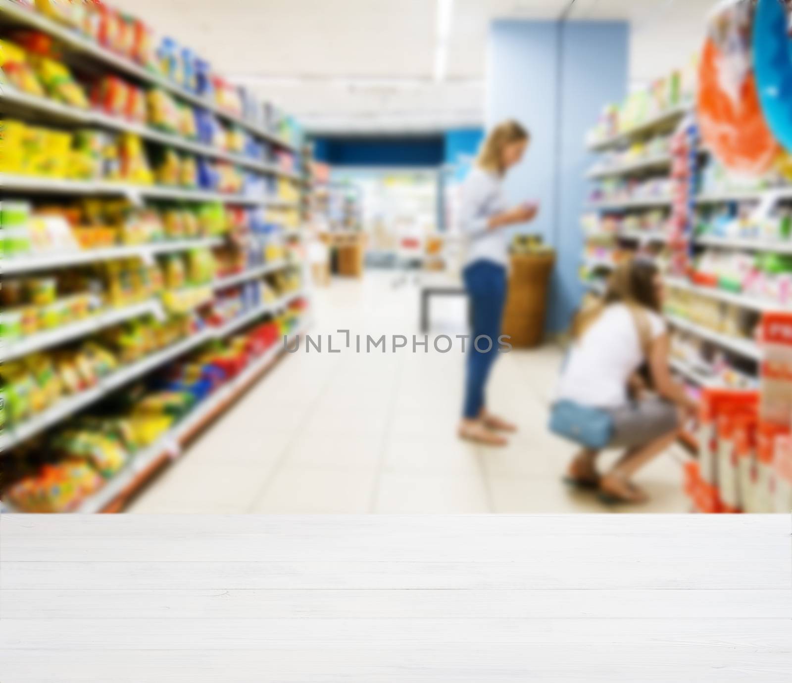 White wooden board empty table in front of blurred background. Perspective white wood over blur in supermarket - can be used for display or montage your products. Mockup for display of product.