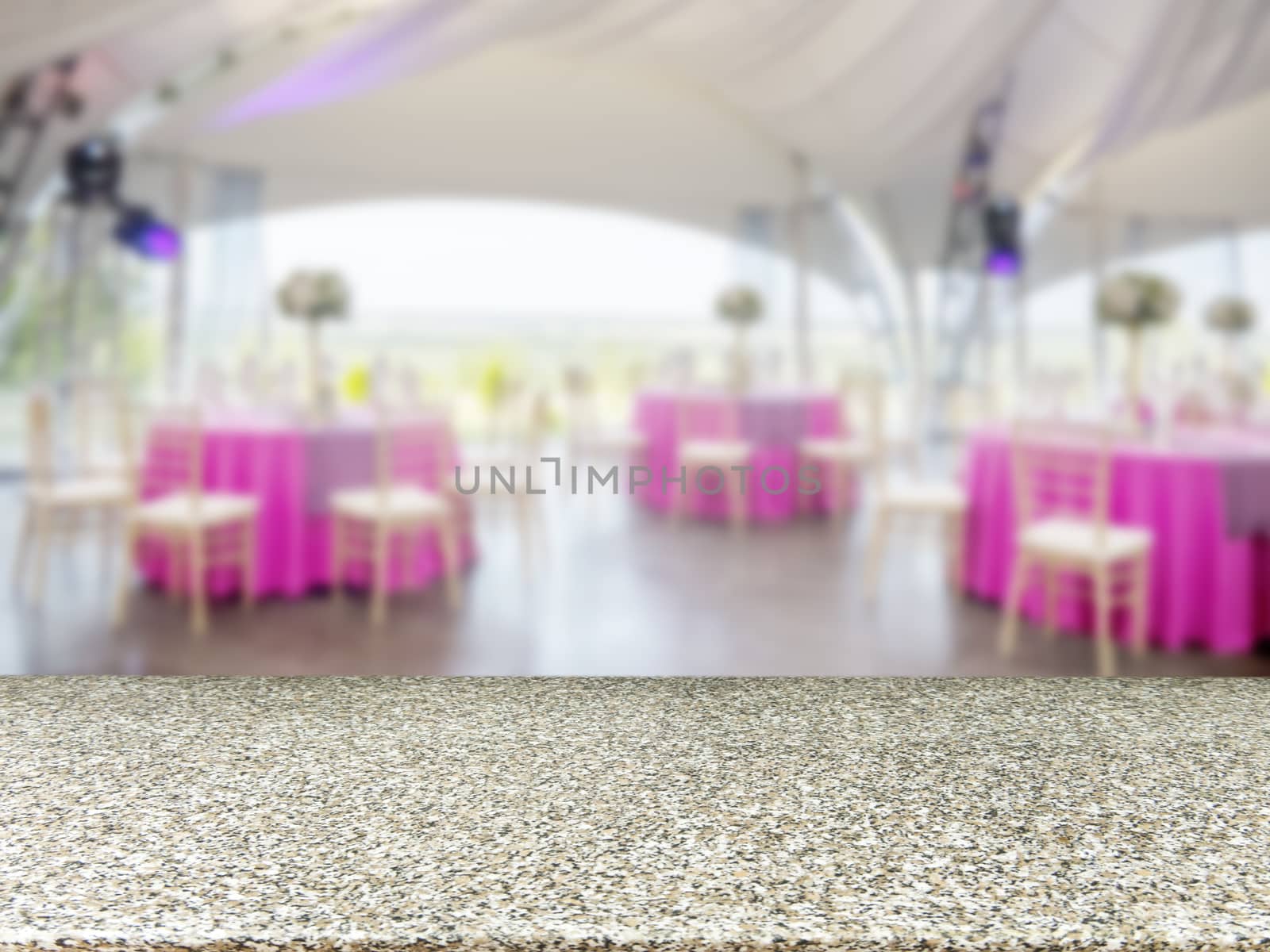 Marble empty table in front of blurred restaurant interior background. Perspective marble board over blur in restaurant or cafe - mockup for display or montage your products