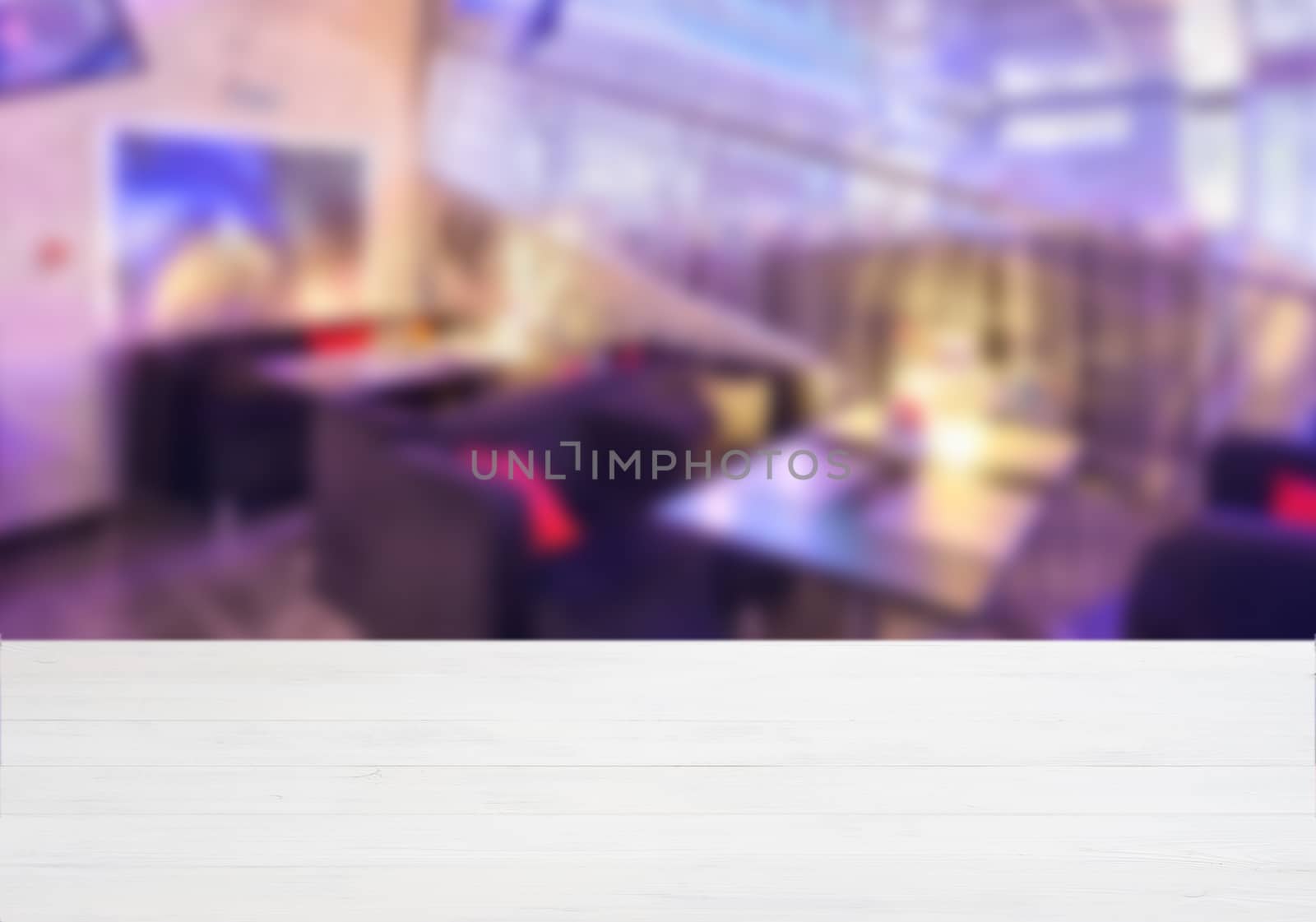 White ooden board empty table in front of blurred background. Perspective whitewood over blur in cafe interior - can be used for display or montage your products. Mockup your products