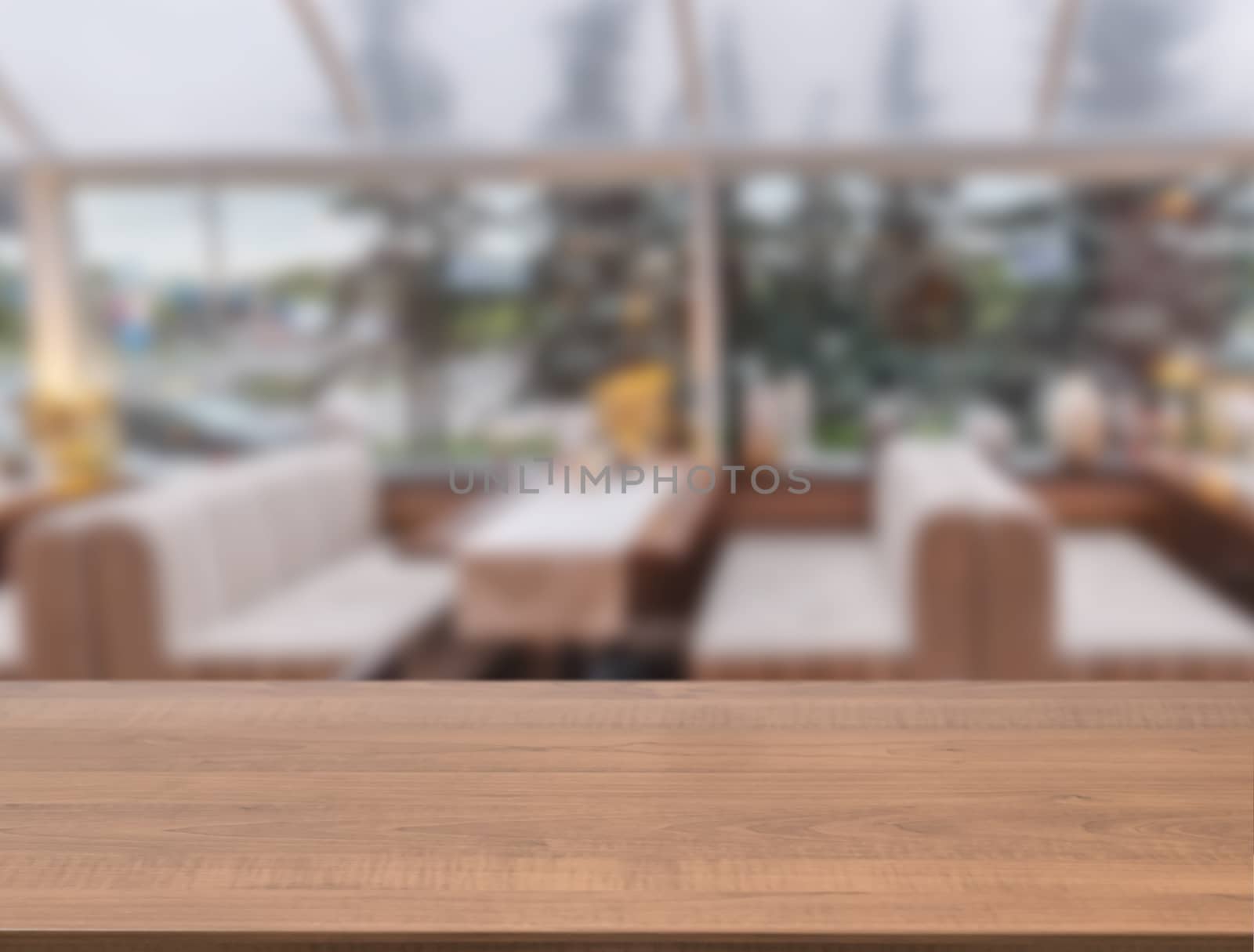 Wooden board empty table in front of blurred cafe by fascinadora
