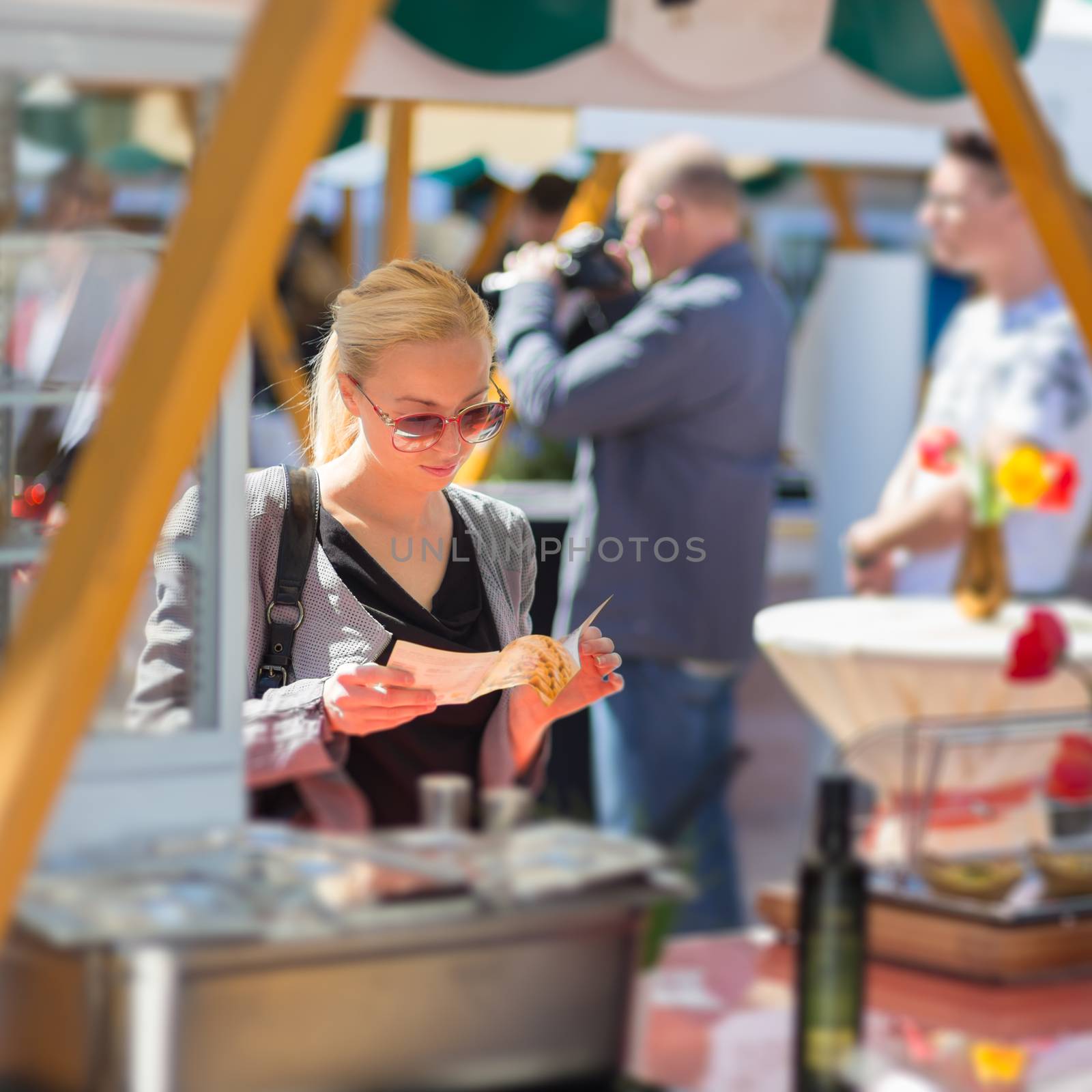 Woman buying meal at street food festival. by kasto