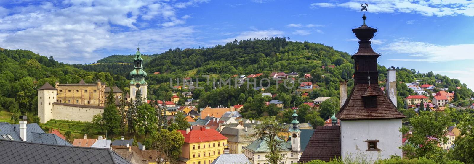 Banska Stiavnica panoramic view with old castle, knocking tower and houses by day, Slovakia