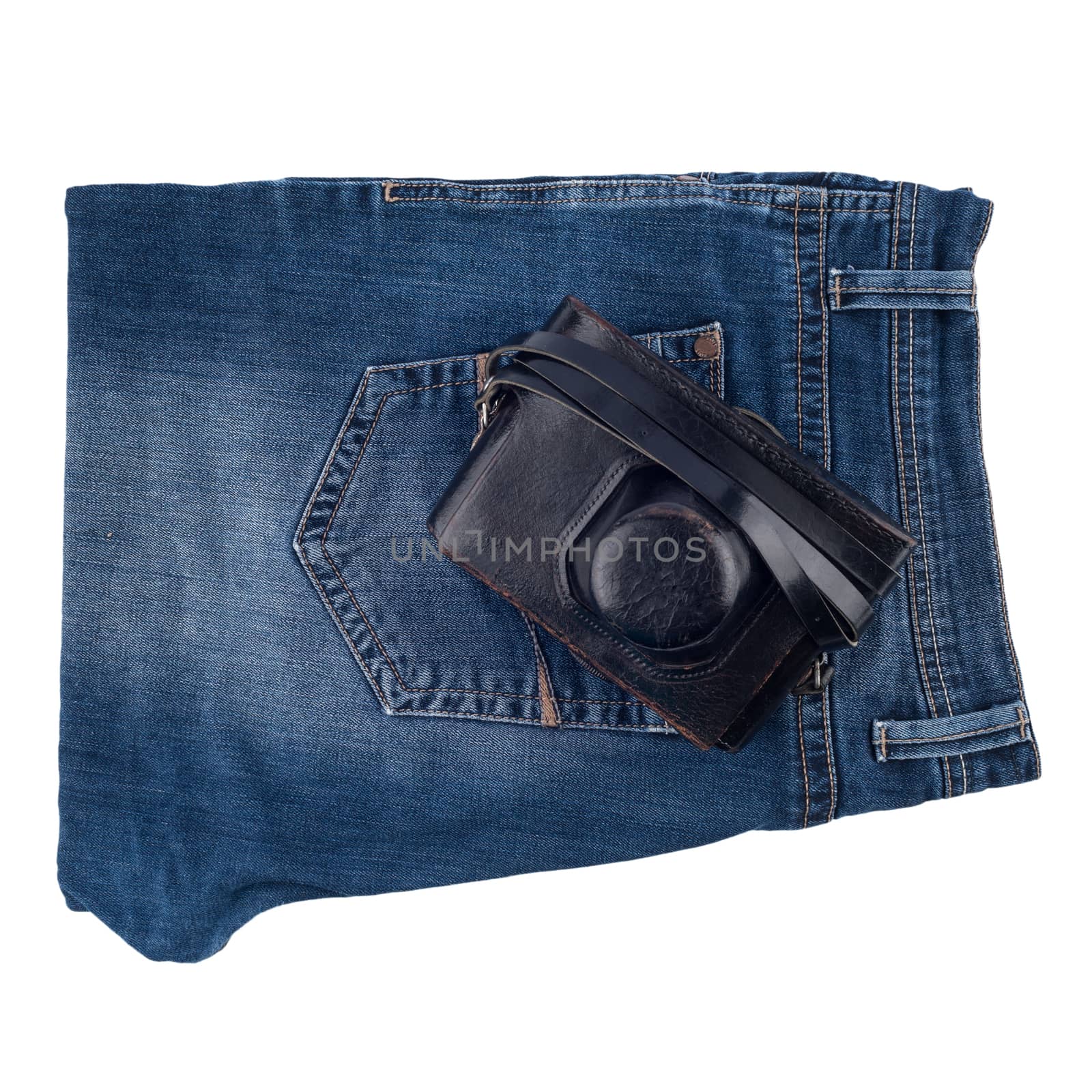 Blue jeans and an old camera isolated on white background.