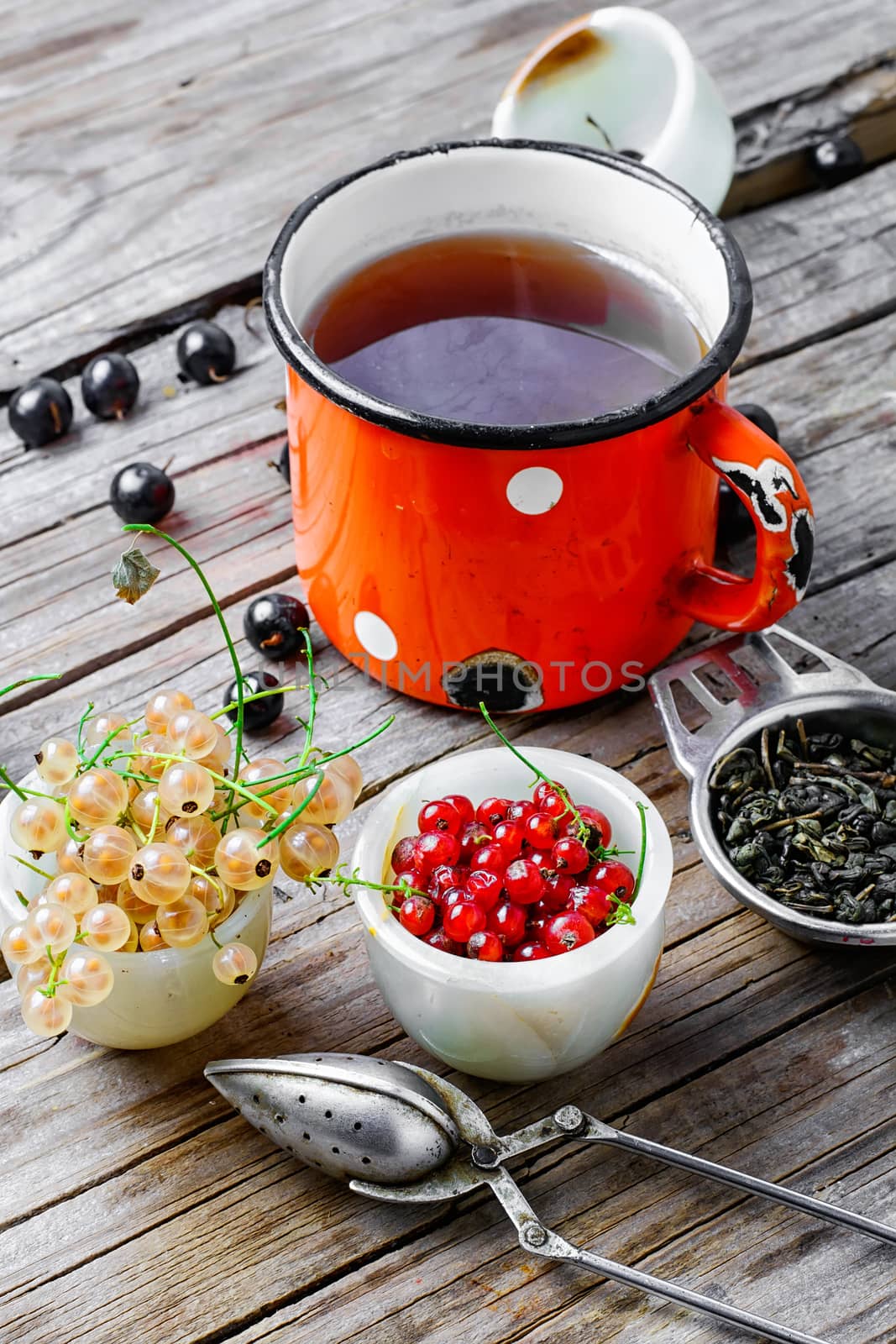 Cup with fragrant tea from the summer village currants