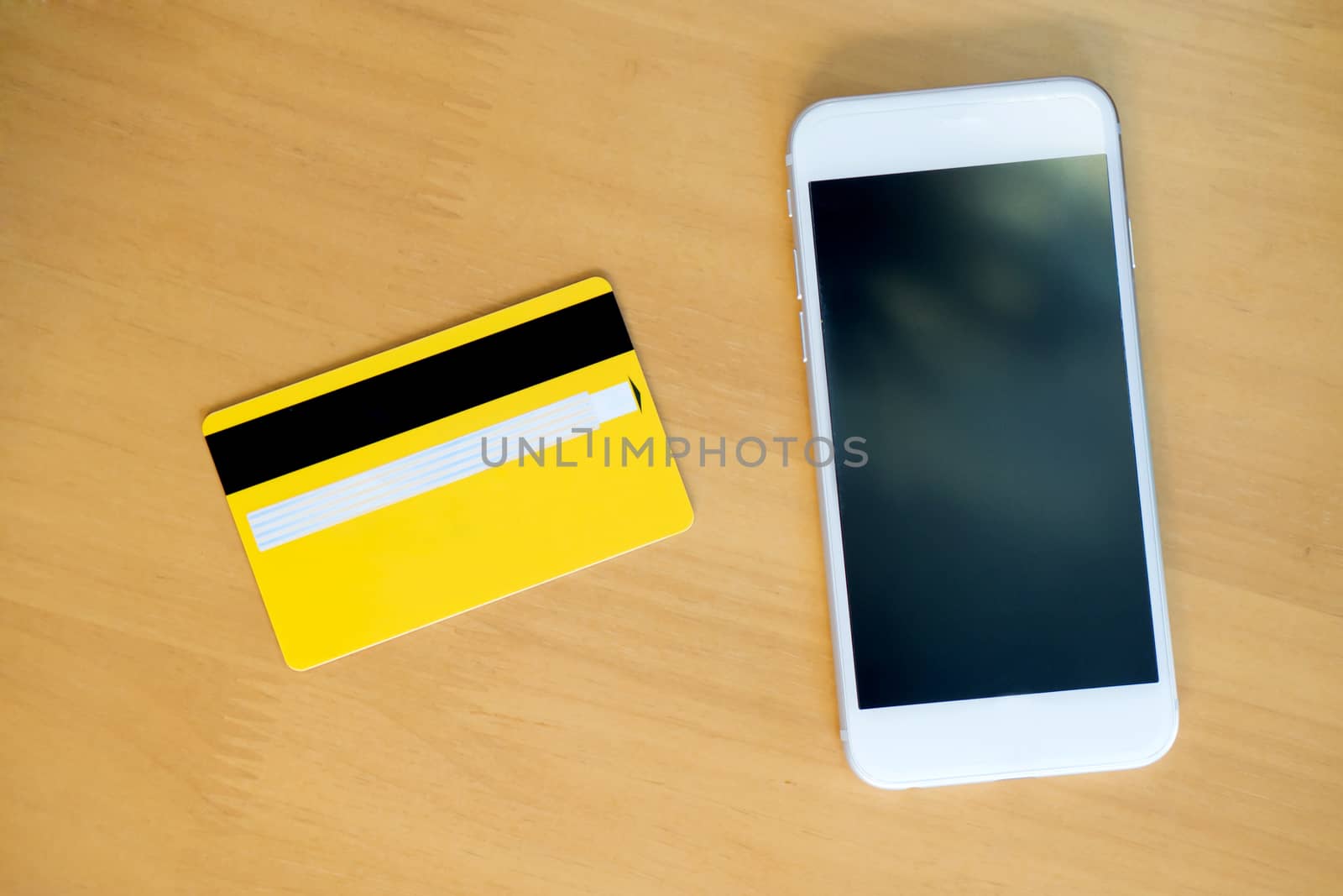 credit card with smartphone on table. View from top.