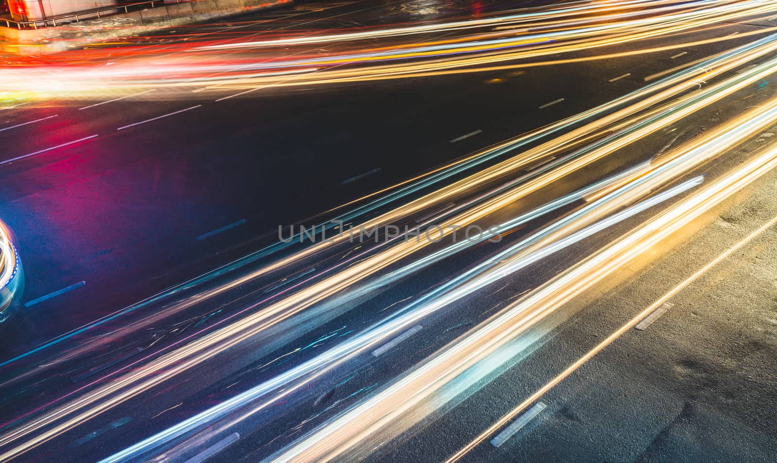 Colorful long exposure light trails across road junction, traffic concept or speed abstract by beer5020