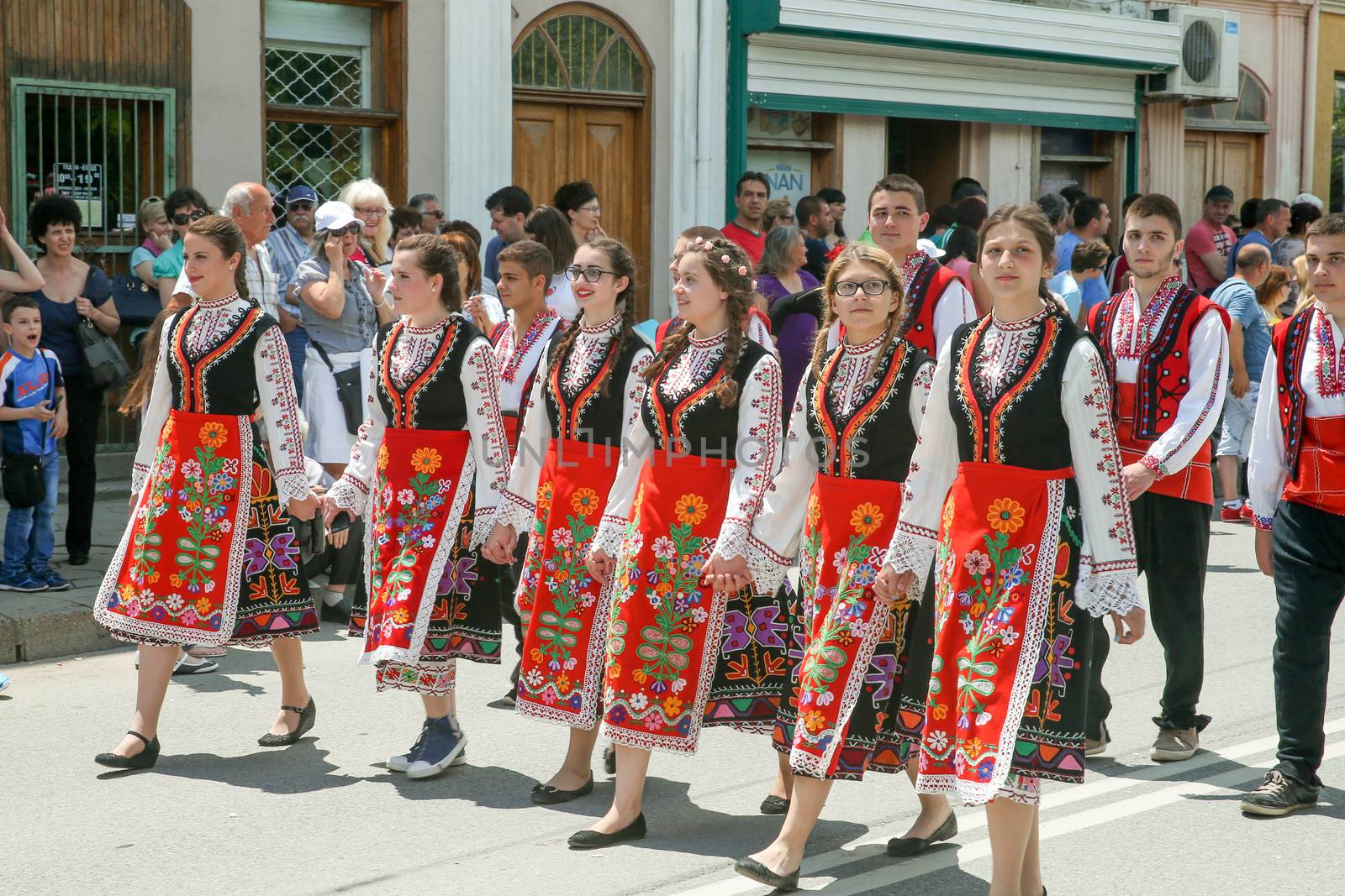 KAZANLAK, BULGARIA - JUNE 05, 2016: Young women are marching in national costumes. At the Rose Festival