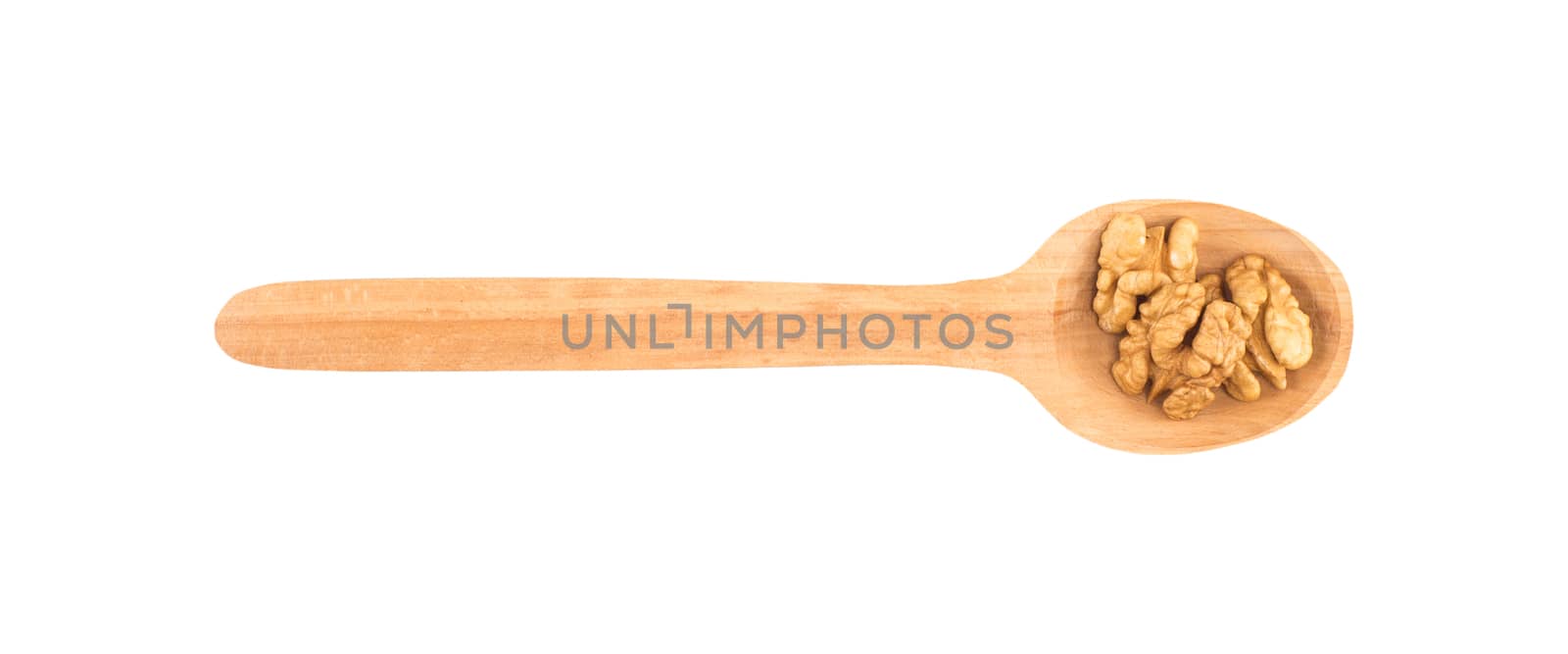 Walnuts on a wooden spoon isolated white background