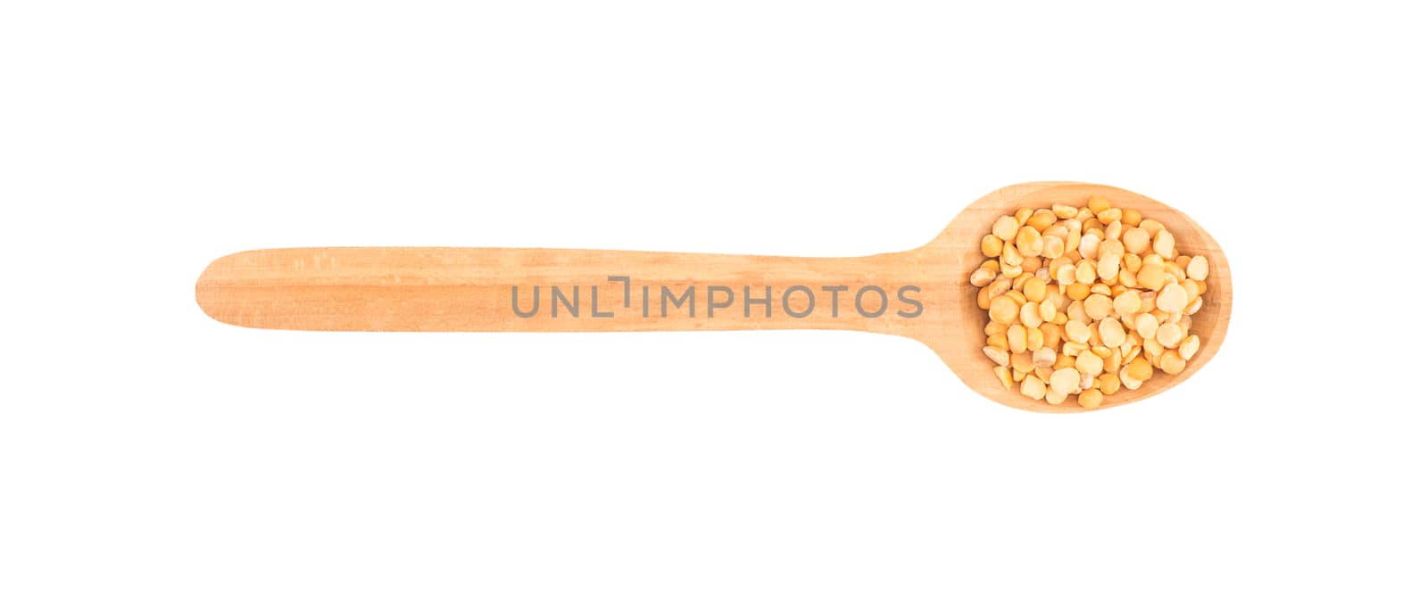 Dried peas in a wooden spoon on a white background