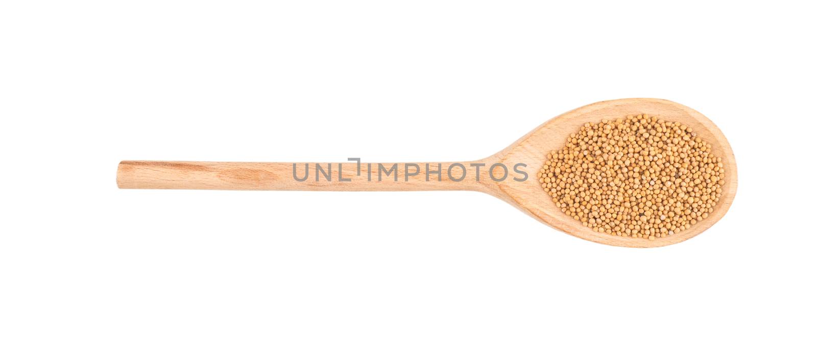 Mustard seeds in wooden scoop over white background by DGolbay