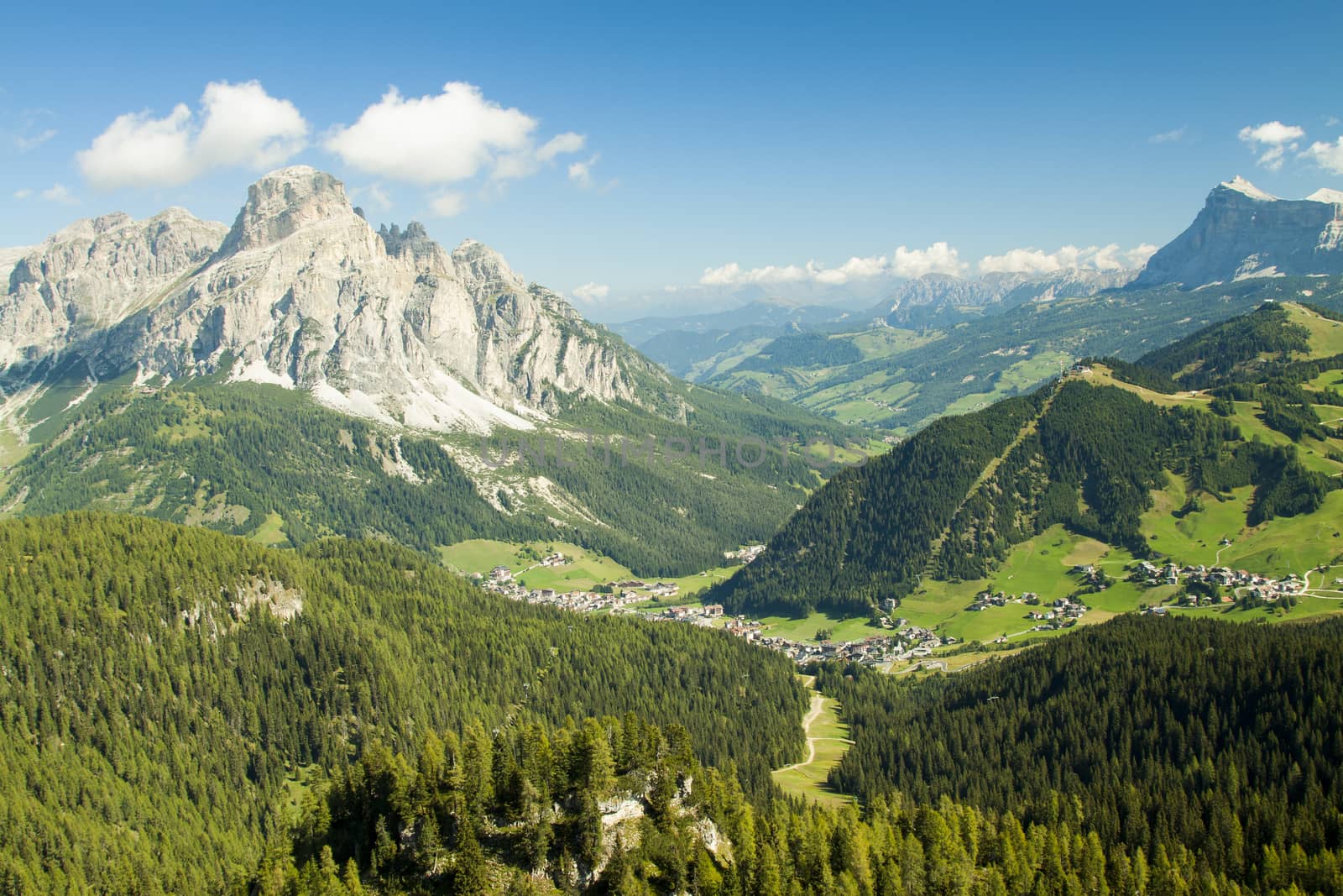 Green valley with the village of Corvara in the dolomities