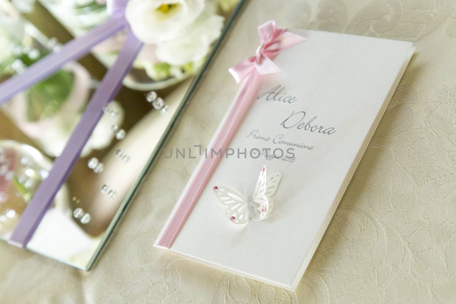 View of a partecipation by invitation with pink ribbon and paper butterfly