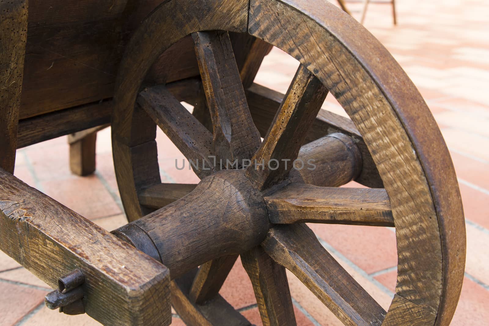 View of a wooden wheel of an ancient wheelbarrow