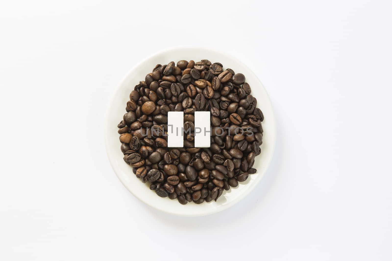 Concept of a coffee pause, coffee beans arranged in a circle with sugar cubes.